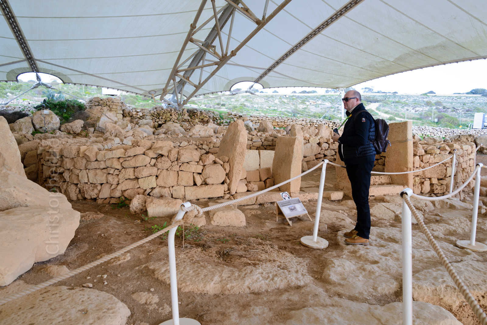 Tourist standing in front of one of the smaller temples at Mnajdra.