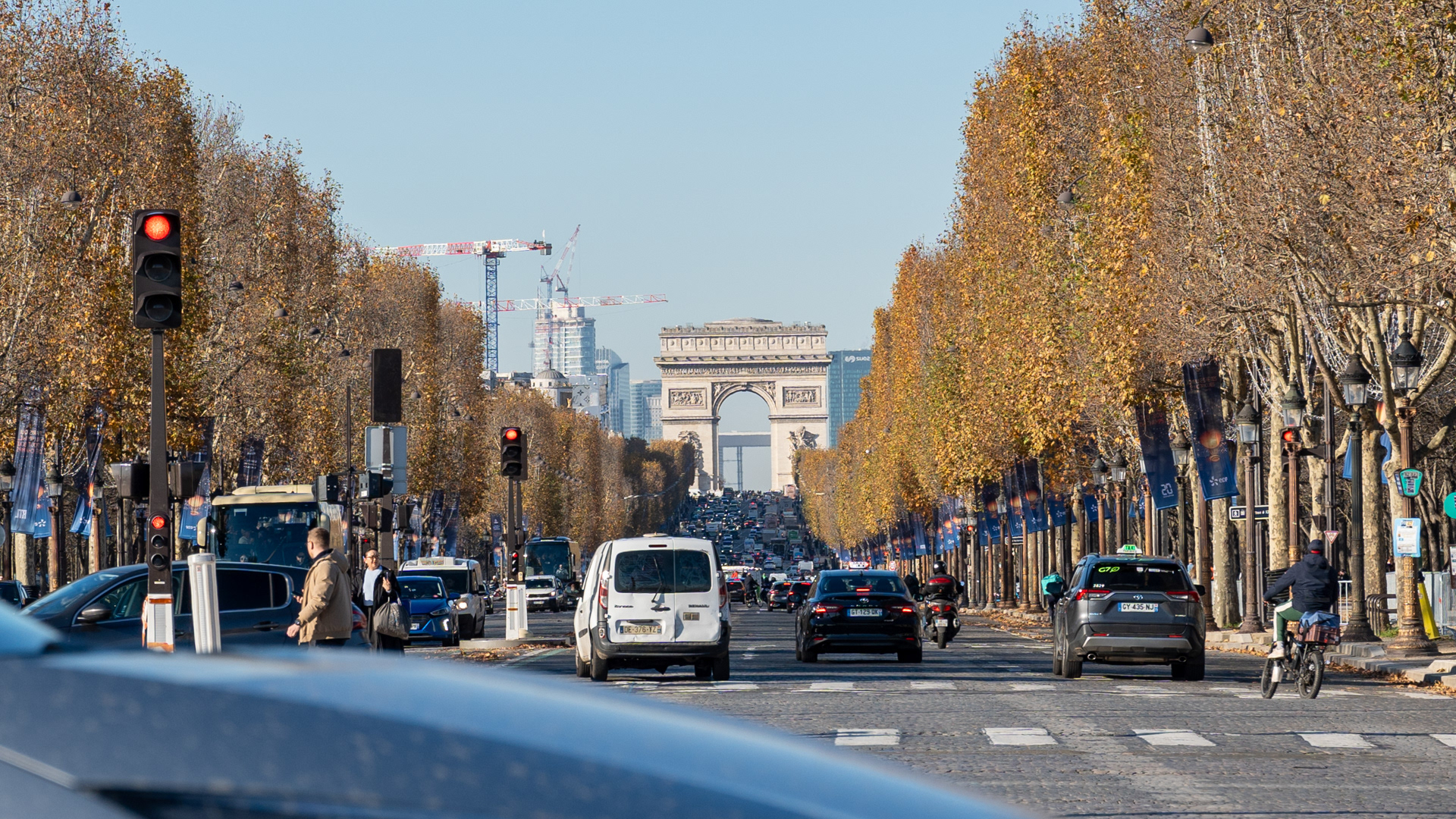 A view of the Arc de Triomphe up the Avenue Des Champs-Élysées. It is an iconic triumphal arch built to commemorate Napoleon's victories.