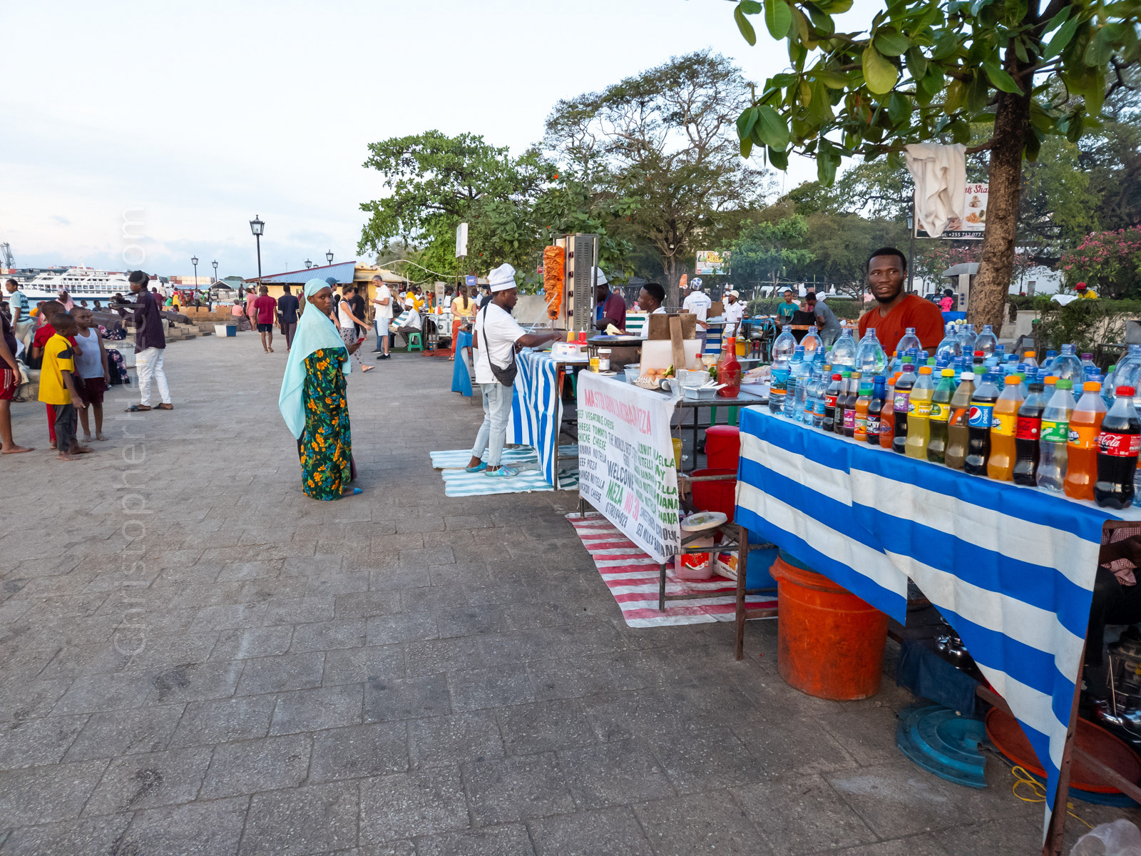 Every night at Forodhani Gardens at Stone Town's waterfront is a busy street food market. There local vendors sell souvenirs and a wide variety of street food, ranging from grilled meats and seafood to a local type of Zanzibari pizza. The quality and hygiene of the food is highly questionable, and there's a lot of hustle going on. But the market is a fun experience and popular destination among tourists and locals alike. Visitors walk the waterfront while watching the sunset over the Indian Ocean while sampling (or not) the grilled delicacies and taking in the colorful environment.