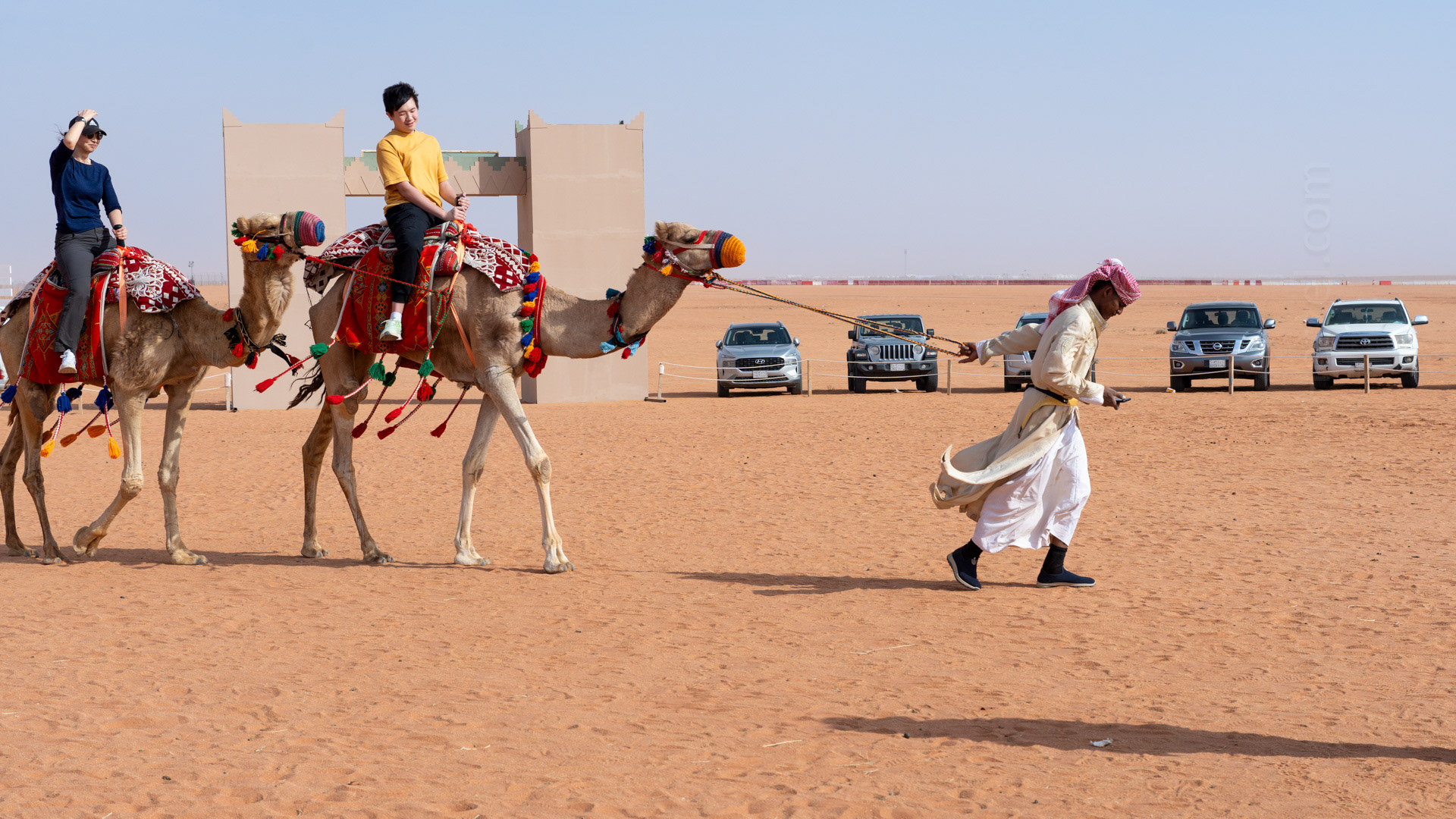 Camel rides were one of the activities available at the Cultural Village. I this photo, I love that the camel wrangler is totally looking at his phone.