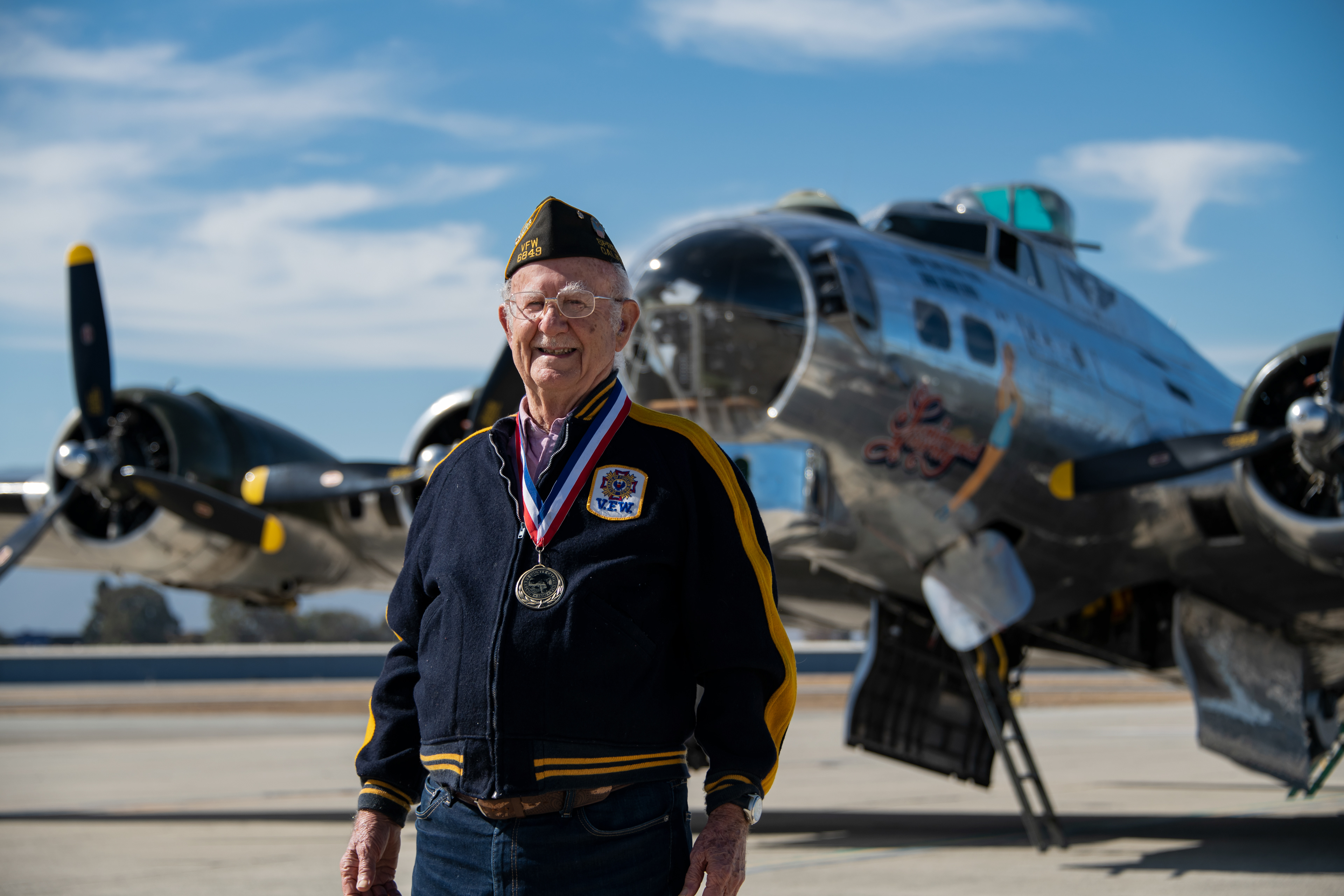 WWII Veteran, Ray Morasca, poses in front of a WWII era B-17 bomber 