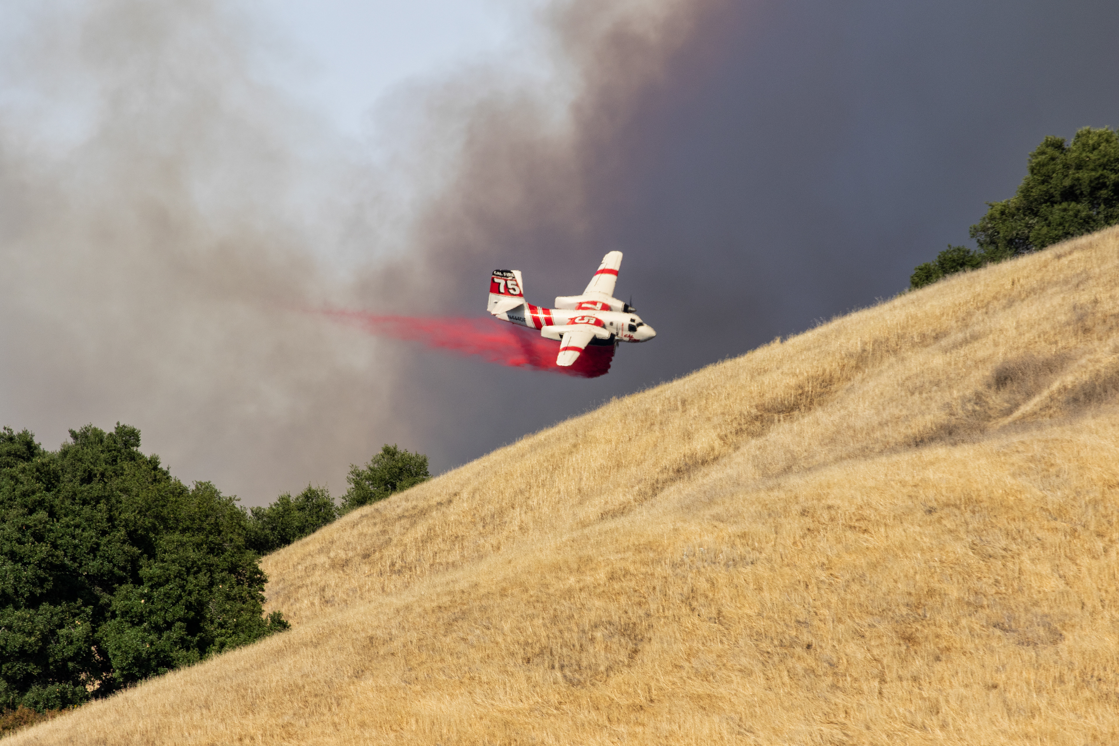 A Cal Fire airtanker drops fire retardant near Mount Toro in Salinas.