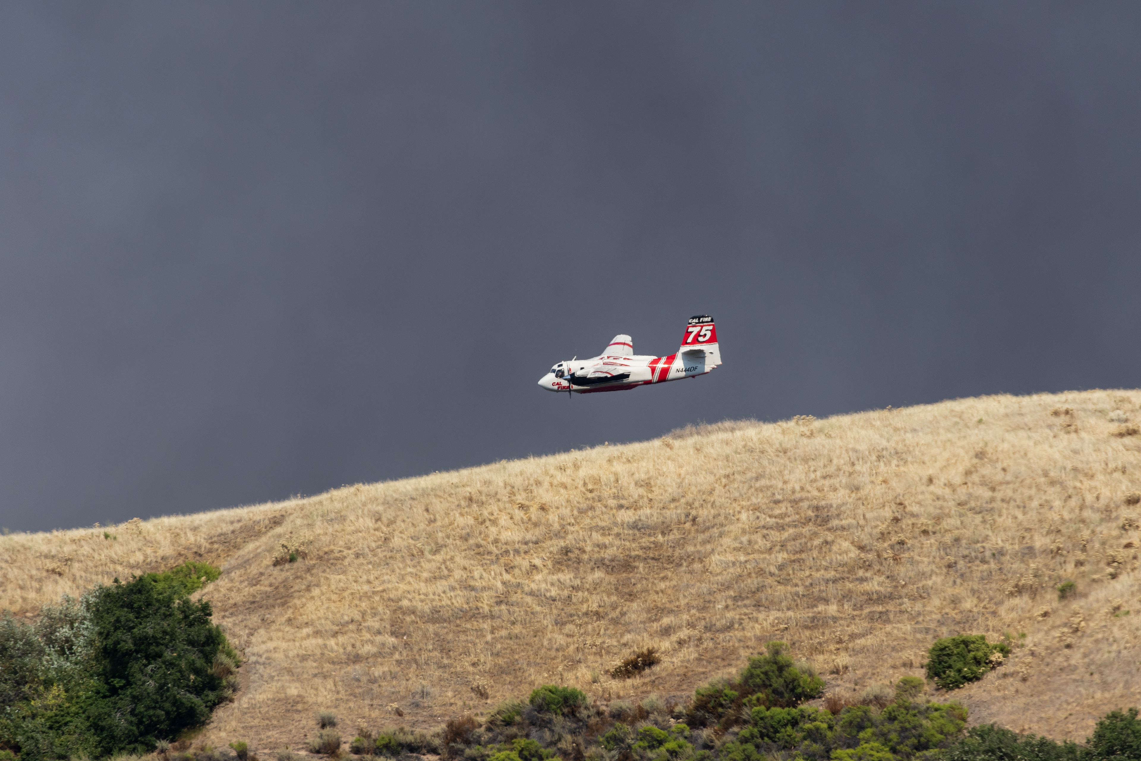 A Cal Fire airtanker prepares to drop fire retardant near Mount Toro in Salinas.