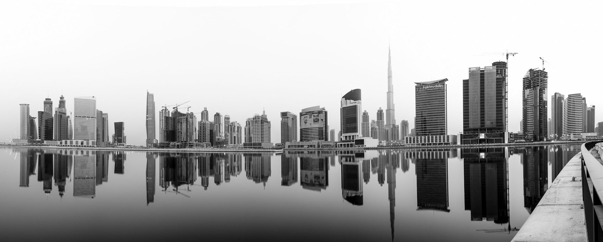 I was returning to Dubai from a nighttime photo shoot and noticed how calm the water was in Business Bay. The actual sunrise was pretty flat and boring, but this panorama was massively improved by conversion to black-and-white.