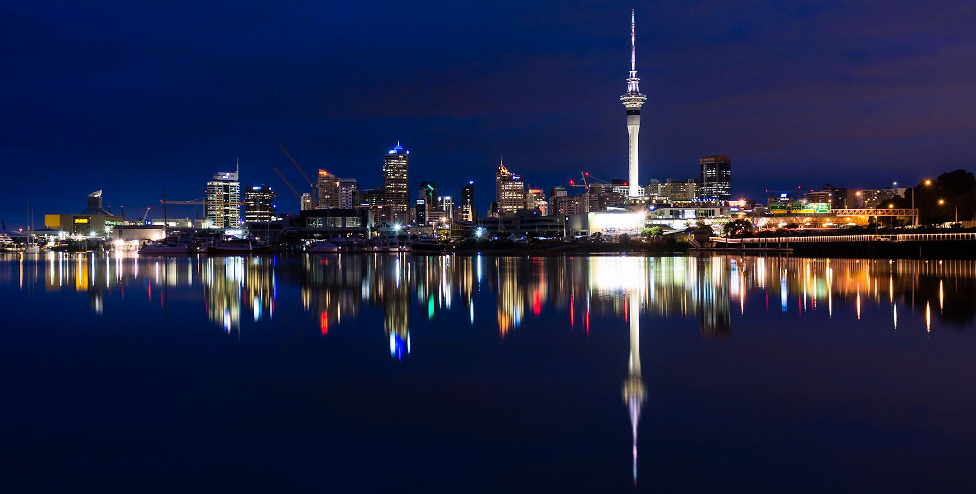 A beautifully still winter's morning in Auckland. The city is waking and Sky Tower  is illuminated.