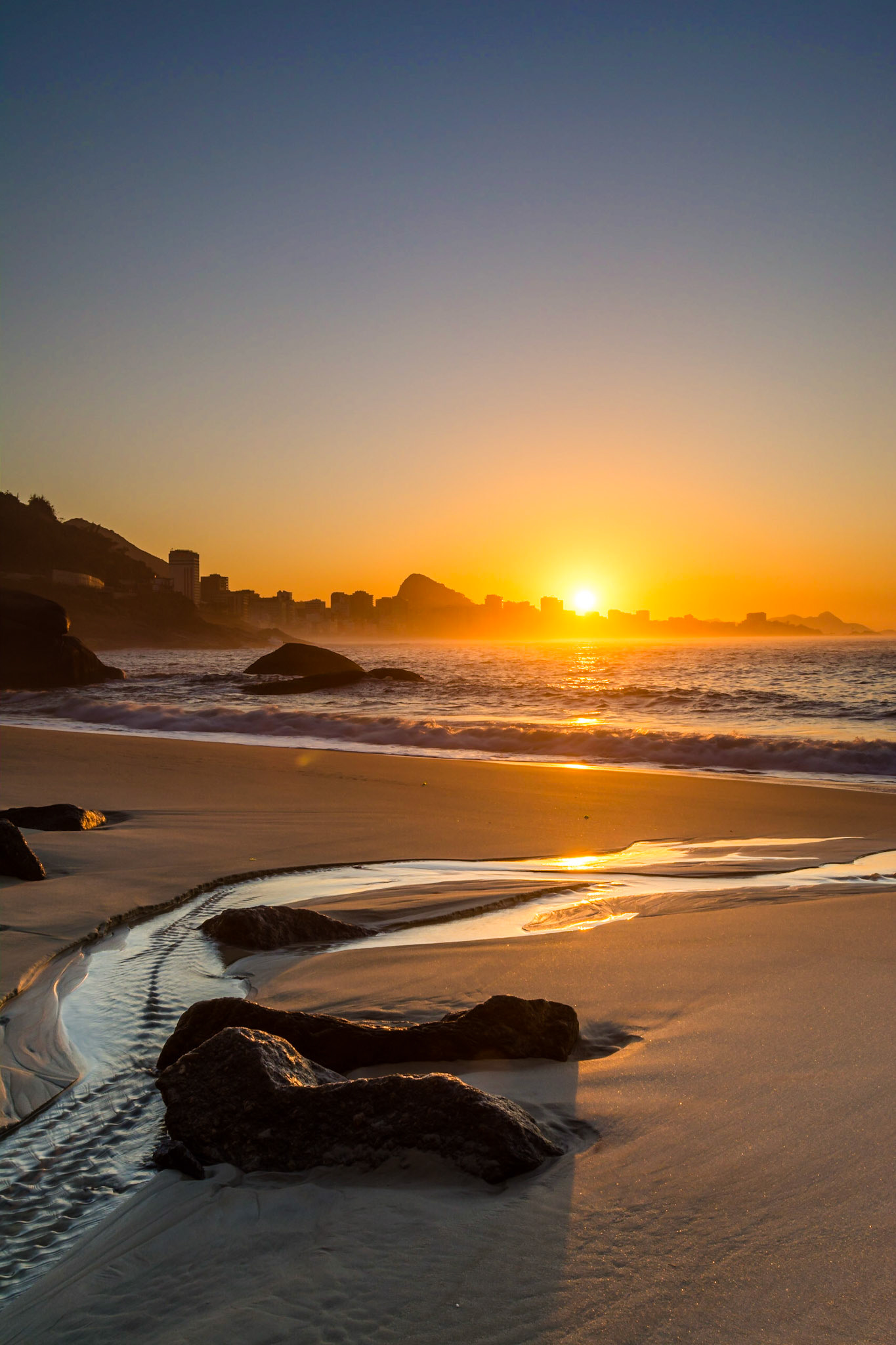 Sunrise in Rio, capturing Ipanema Beach, the town of Leblon and Sugarloaf Mountain.