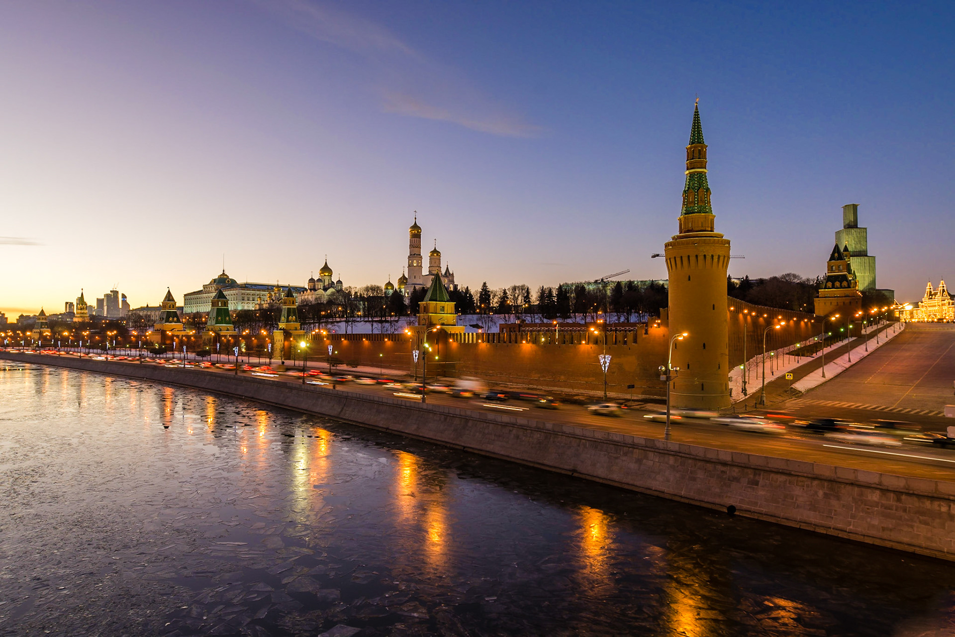 Looking along the outer wall from one of the massive towers which line the Kremlin, overlooking the Moskva River at sunset. One of the towers is undergoing restoration.