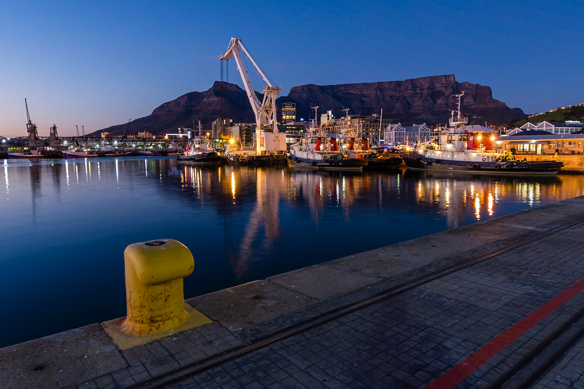 Sunrise at the  Victoria and Alfred Waterfront harbour in Cape Town, with Table Mountain in the background.