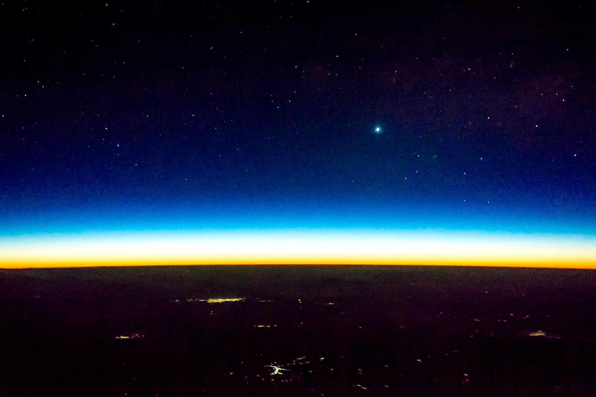 Eastbound over the border between Myanmar and China, the sun is just about to rise over the horizon. The bright 'star' is Venus.