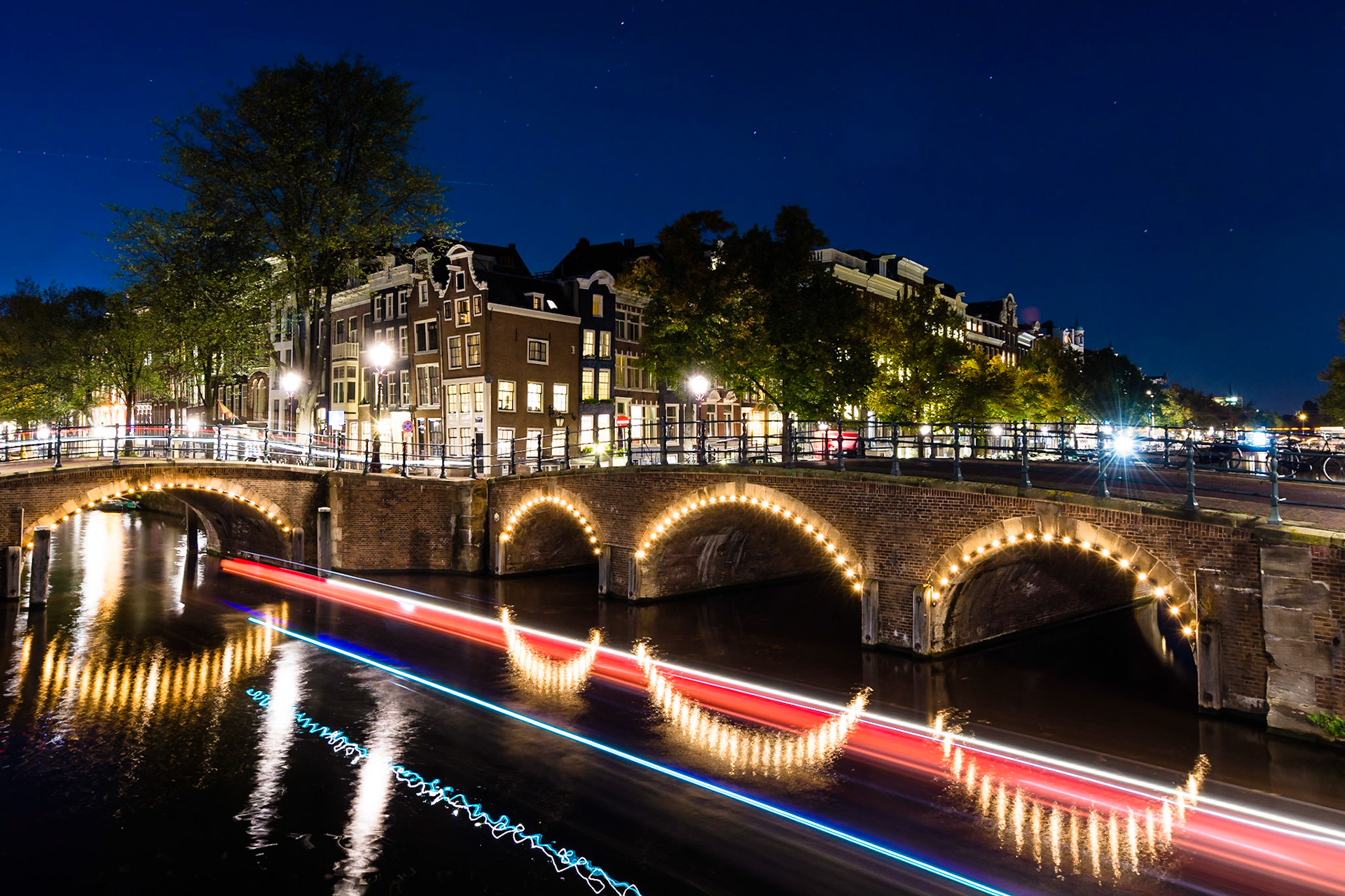 Reflection on the waterways of Amsterdam after sunset.