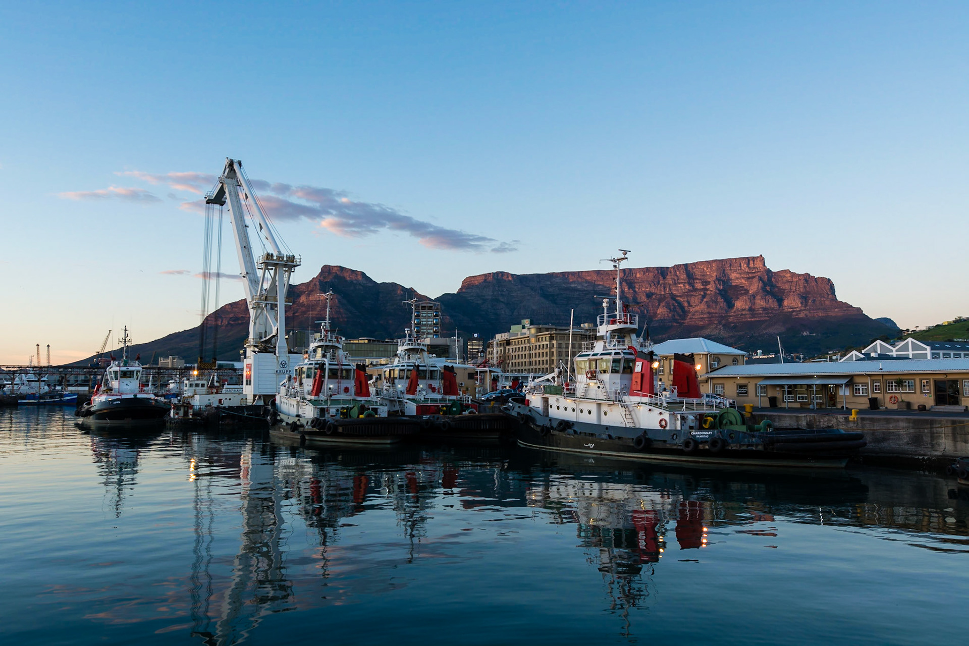Sunrise at the  Victoria and Alfred Waterfront harbour in Cape Town, with Table Mountain in the background.
