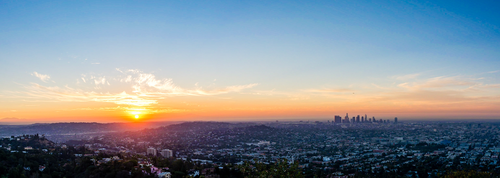 The sun rises over the horizon to the east of Los Angeles and a new day begins.