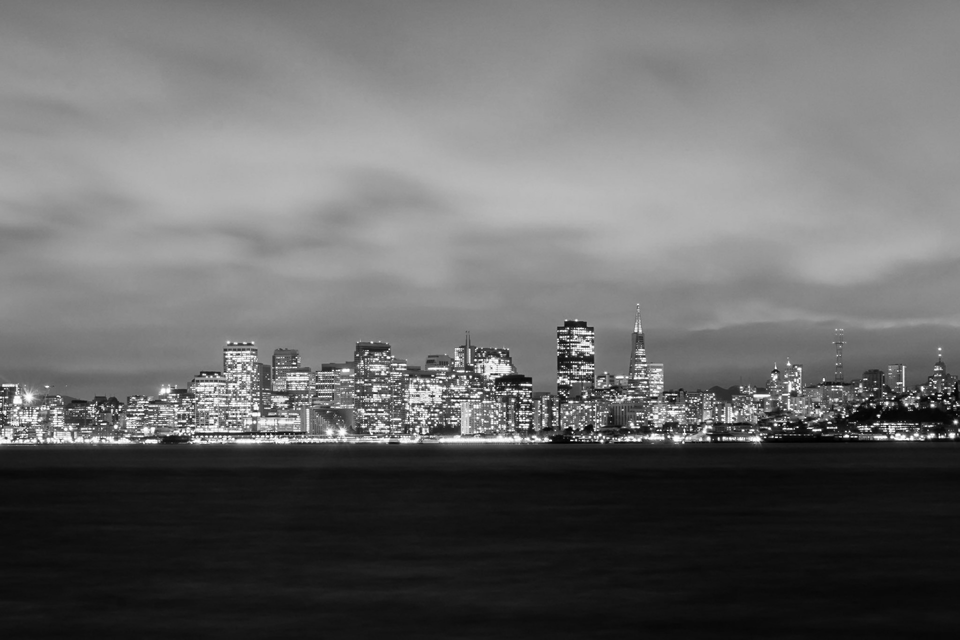 Taken after sunset, downtown San Fransisco is the boundary between the inky-black sea and the cloudy sky.