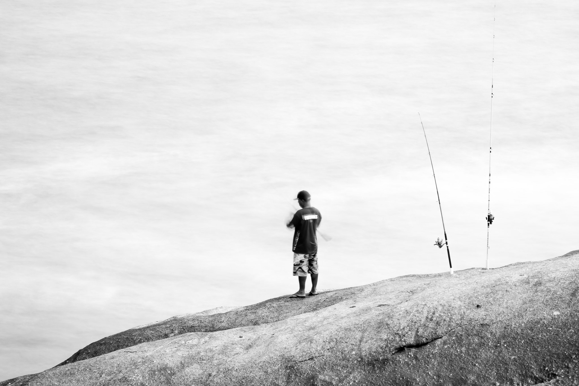 RIO DE JANEIRO, BRAZIL - APRIL 5 2015: Fishermen practice their skill on the rocks of Pedro do Arpoador