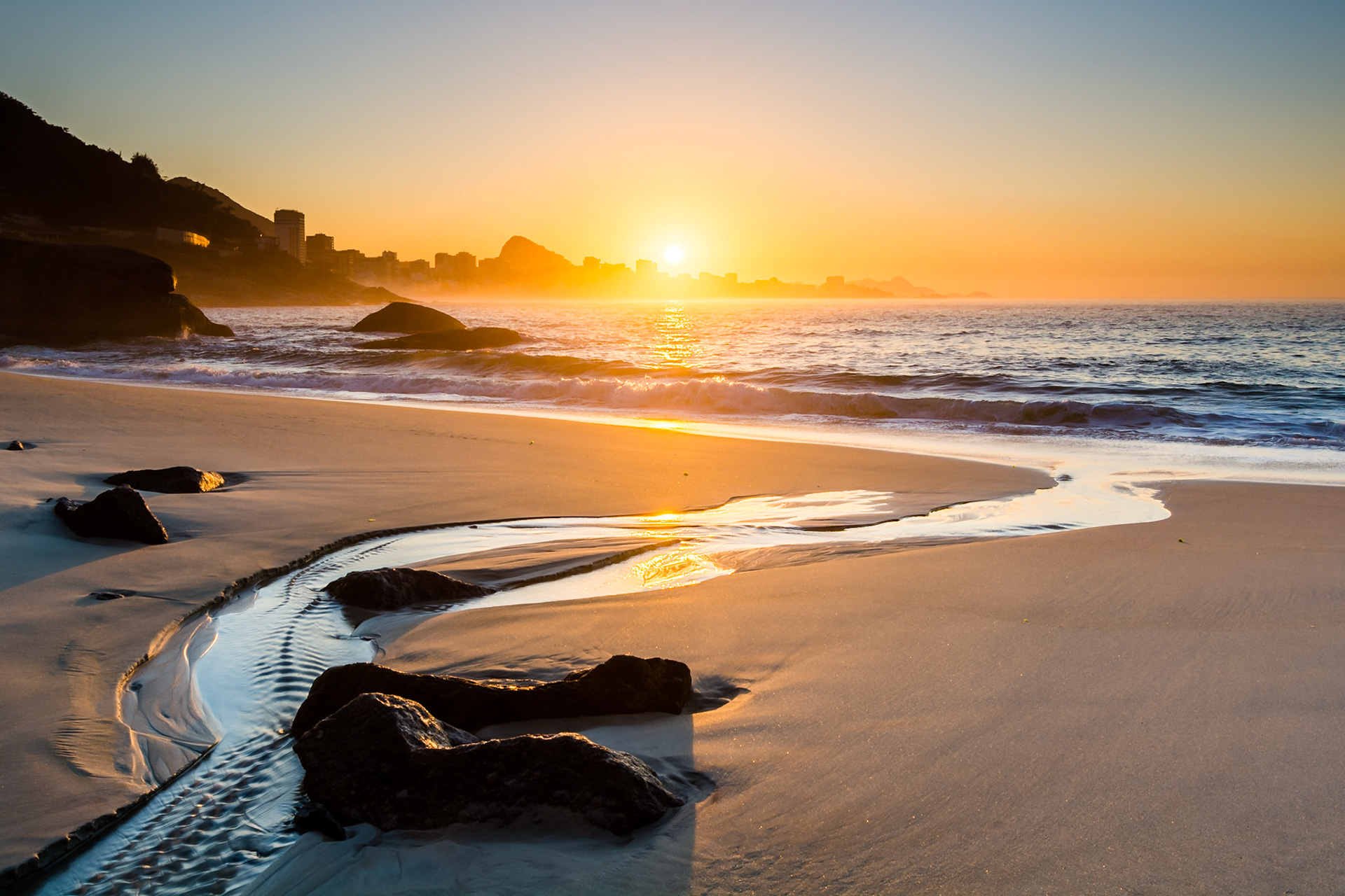 Sunrise in Rio, capturing Ipanema Beach, the town of Leblon and Sugarloaf Mountain.