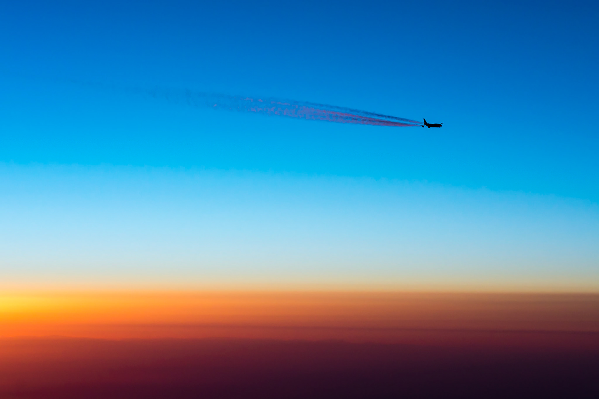 This was a once-in-a-lifetime photo. We were flying from Houston to Dubai, approaching the southern tip of Greenland at sunrise, just about to enter North Atlantic airspace. This British Airways 747 Jumbo Jet was just ahead on exactly the same airway.  I could see the scene developing and as we entered the airspace he offset 1nm right and we offset 2nm right (a standard procedure over the ocean) - and as the sun rose it was perfect!