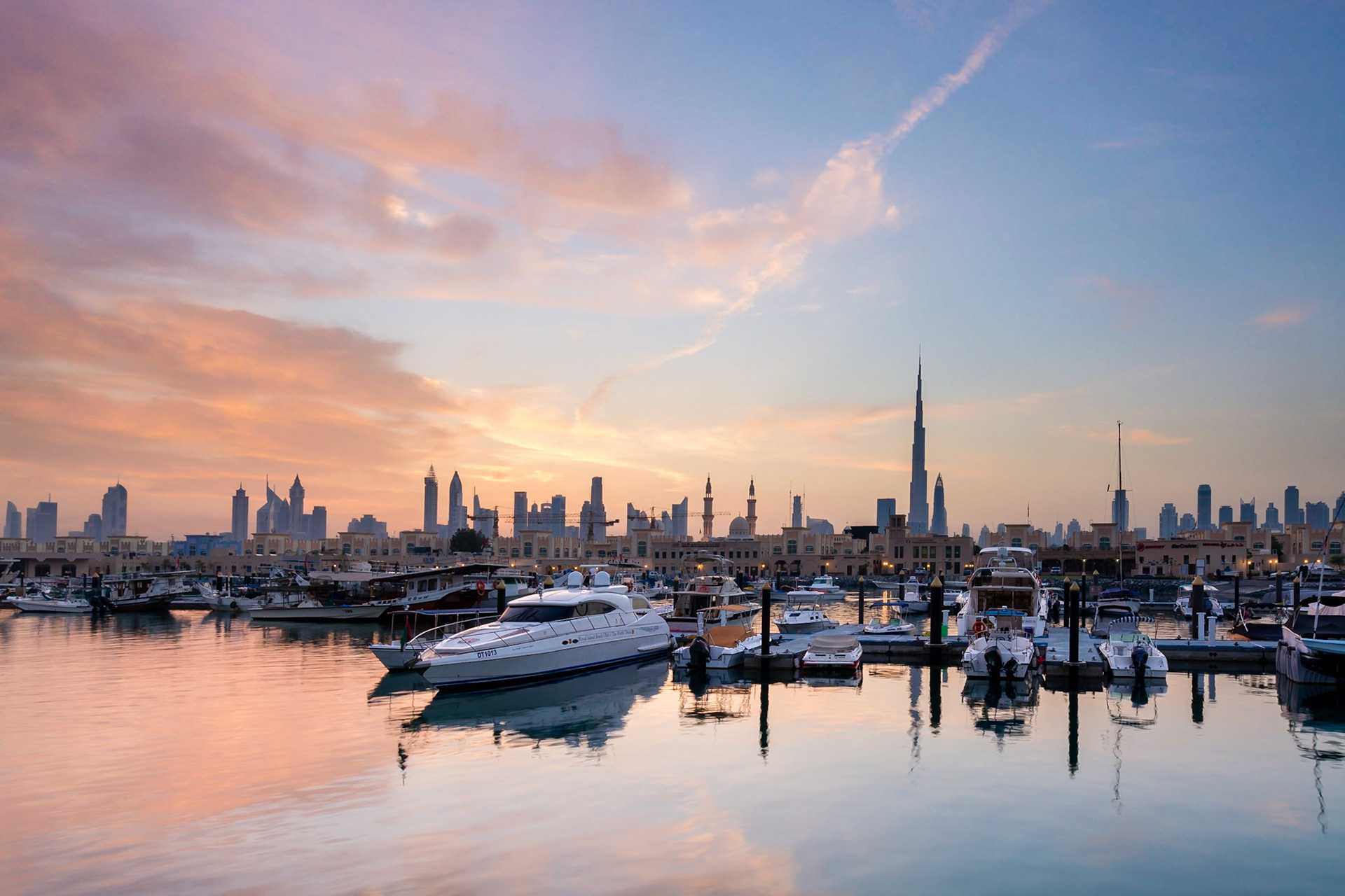 Sunrise over Jumeirah Fishing Village in Dubai, UAE. The Fishermans Village is a quiet spot in the Dubai coastline, featuring the harbour, cafes, restaurants and boat-building.