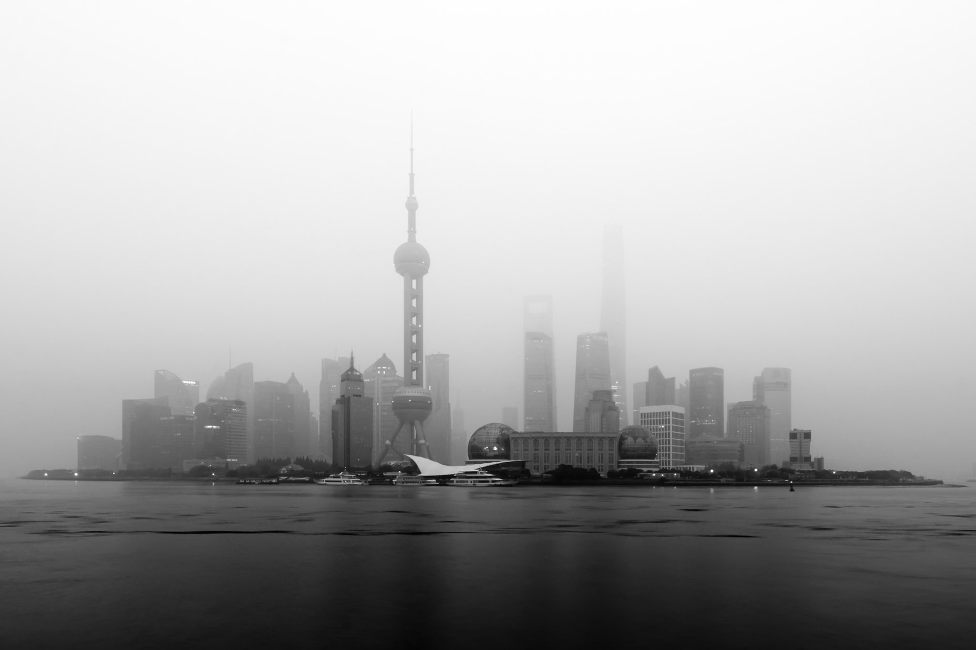 Another morning over Lujiazui District in Shanghai. This morning suffered from low haze coupled with pollution to give low visibility and challenging photography conditions. Converted to black and white to exaggerate the effect of the haze.