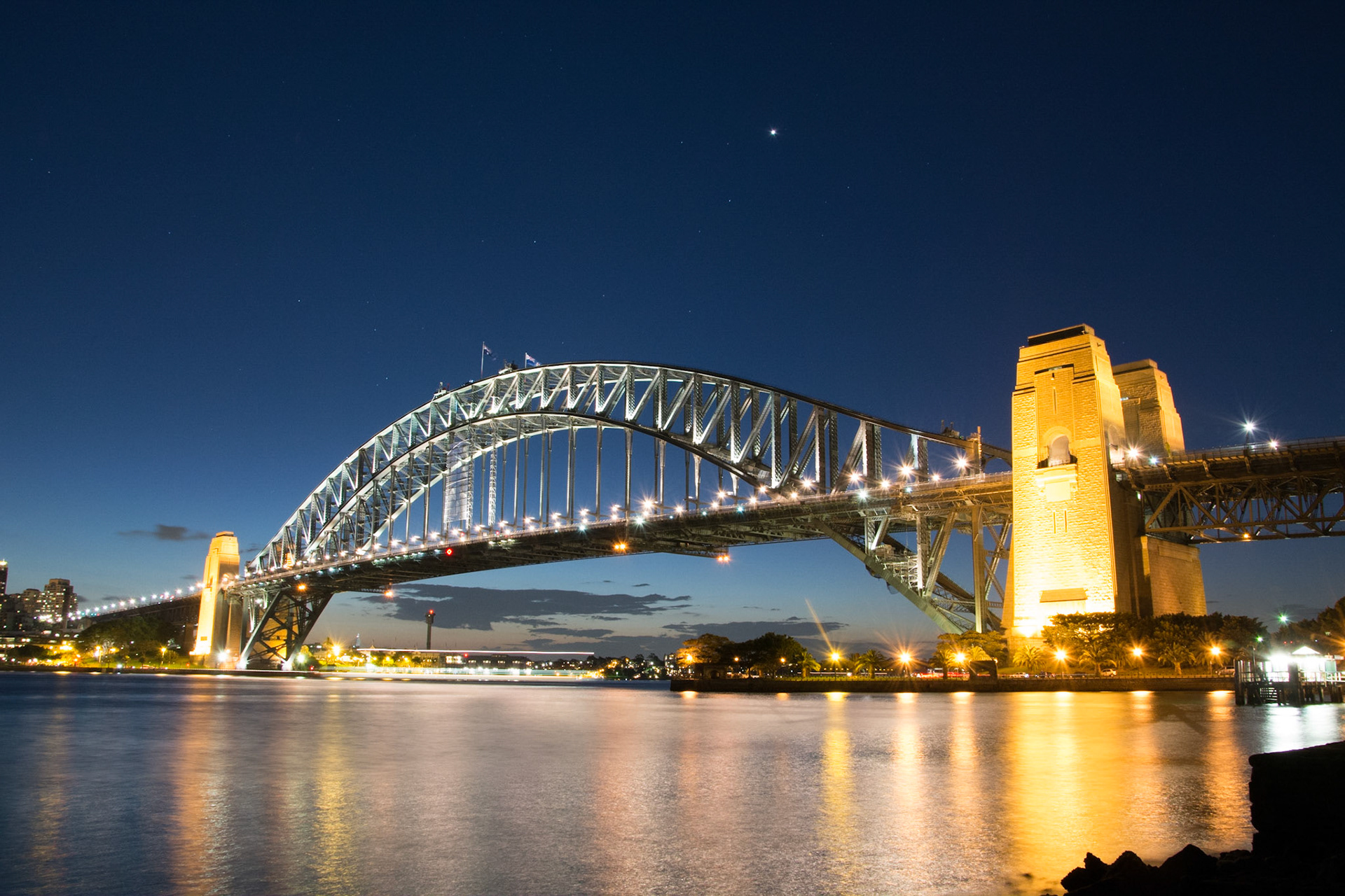 Taken shortly after sunset near to Jeffery's Street Wharf, the light-trail of a passing boat can be seen under the bridge.