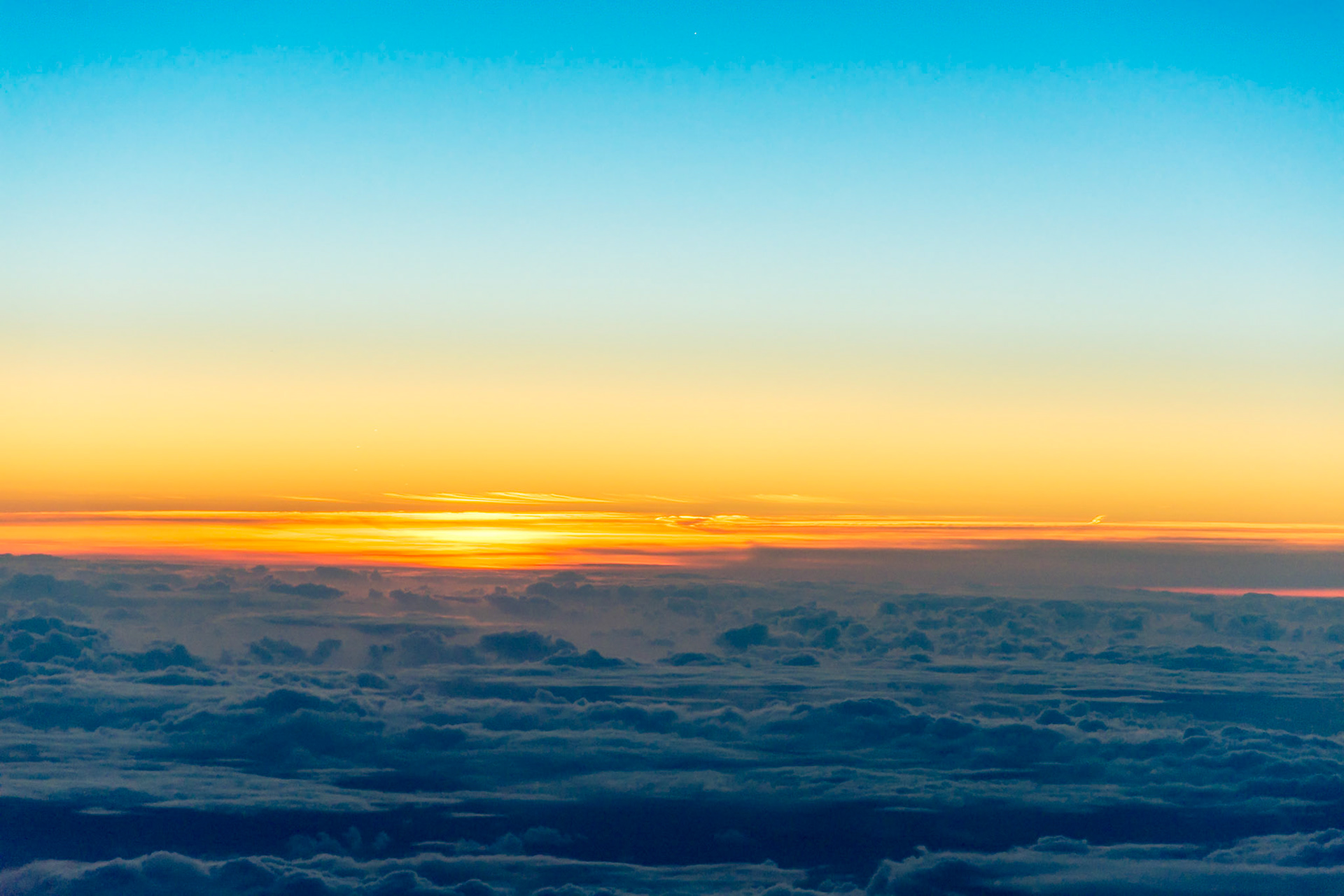 Returning from New York, the sun rises over the Atlantic.