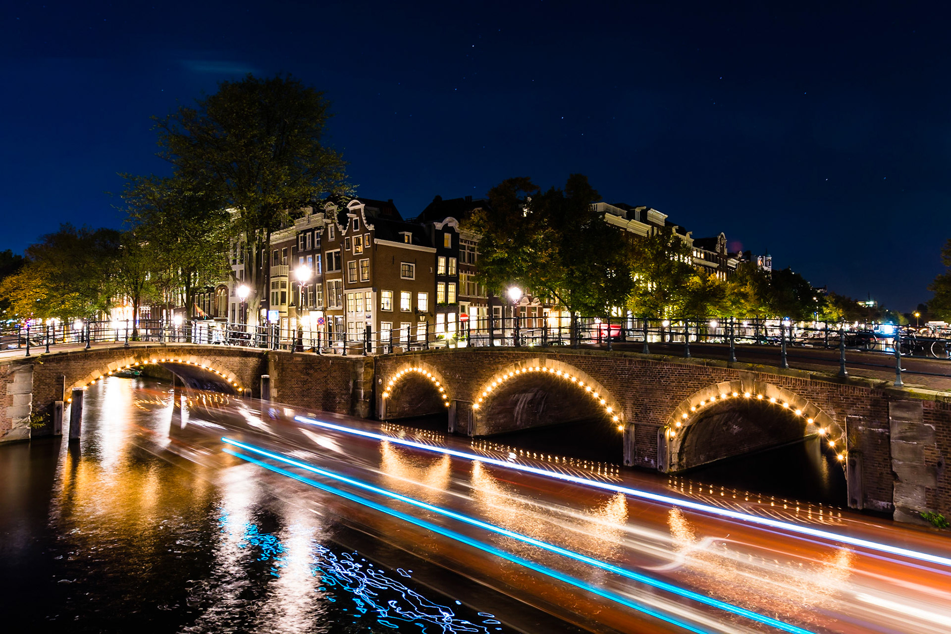 Reflection on the waterways of Amsterdam after sunset.