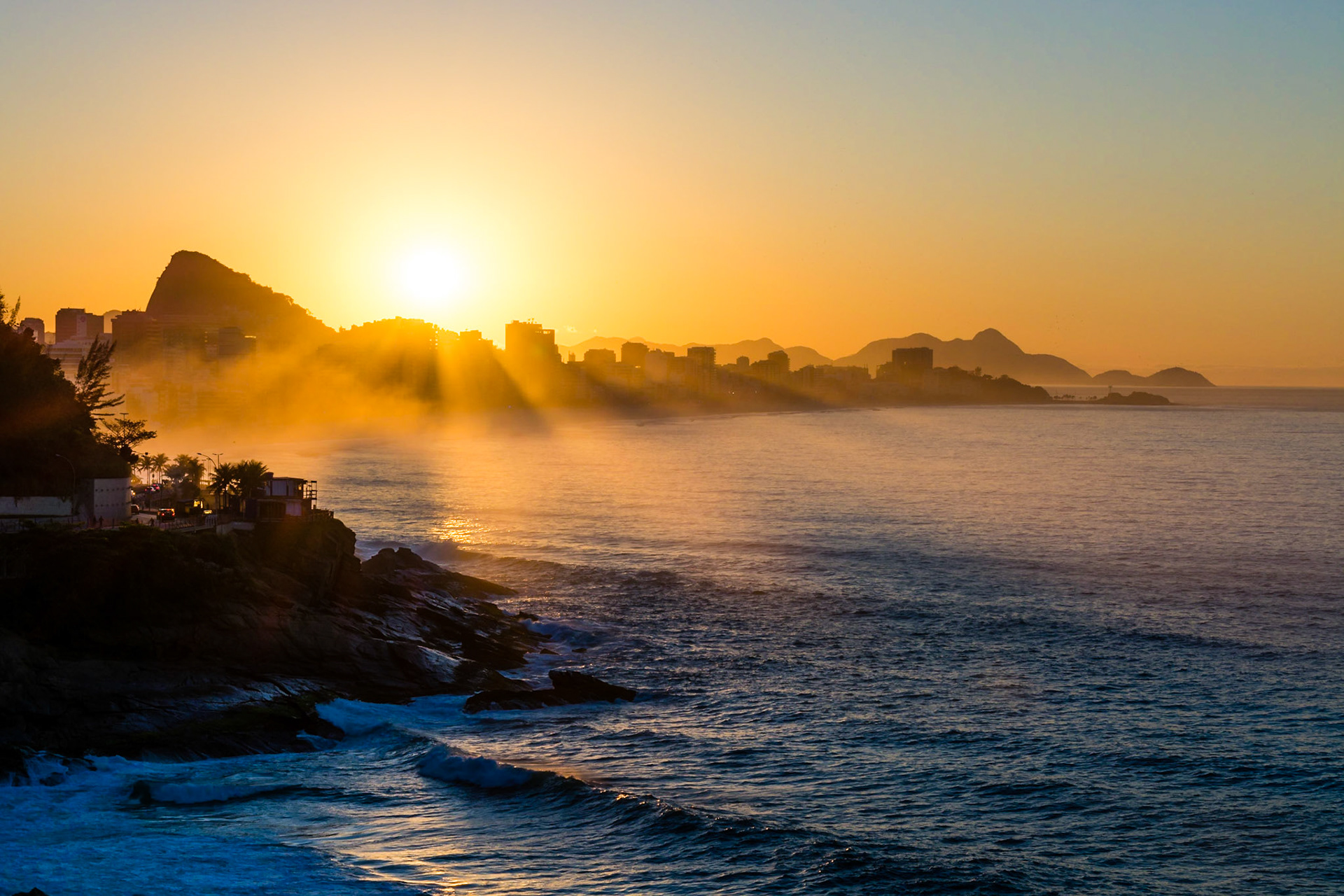 Sunrise in Rio, capturing Ipanema Beach, the town of Leblon and Sugarloaf Mountain.