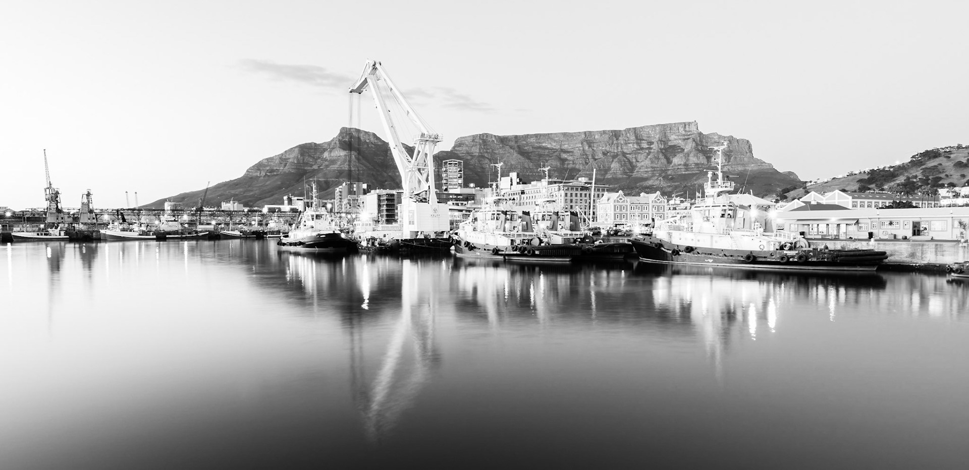 Sunrise at the  Victoria and Alfred Waterfront harbour in Cape Town, with Table Mountain in the background.