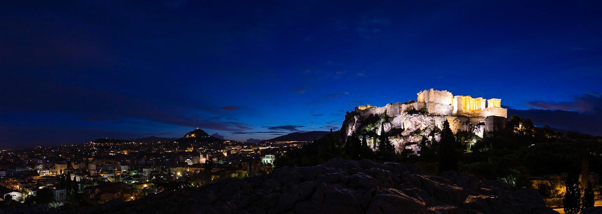 Sunrise in Athens, Greece. Taken from Areopagus Hill, the Acropolis can been seen on the right, Mount Lycabettus in the centre, and the Stoa of Attalos on the far left.