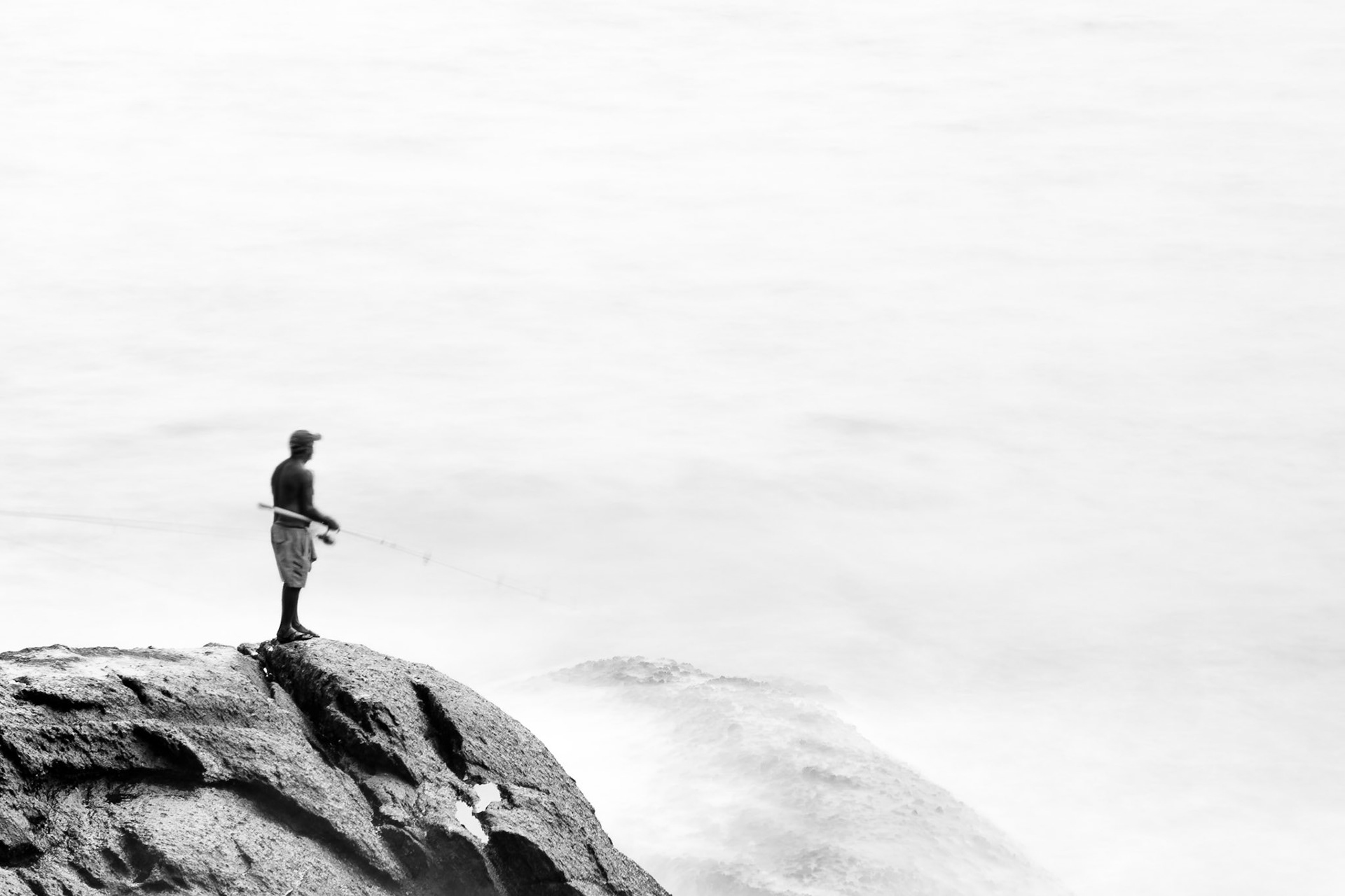 RIO DE JANEIRO, BRAZIL - APRIL 5 2015: Fishermen practice their skill on the rocks of Pedro do Arpoador