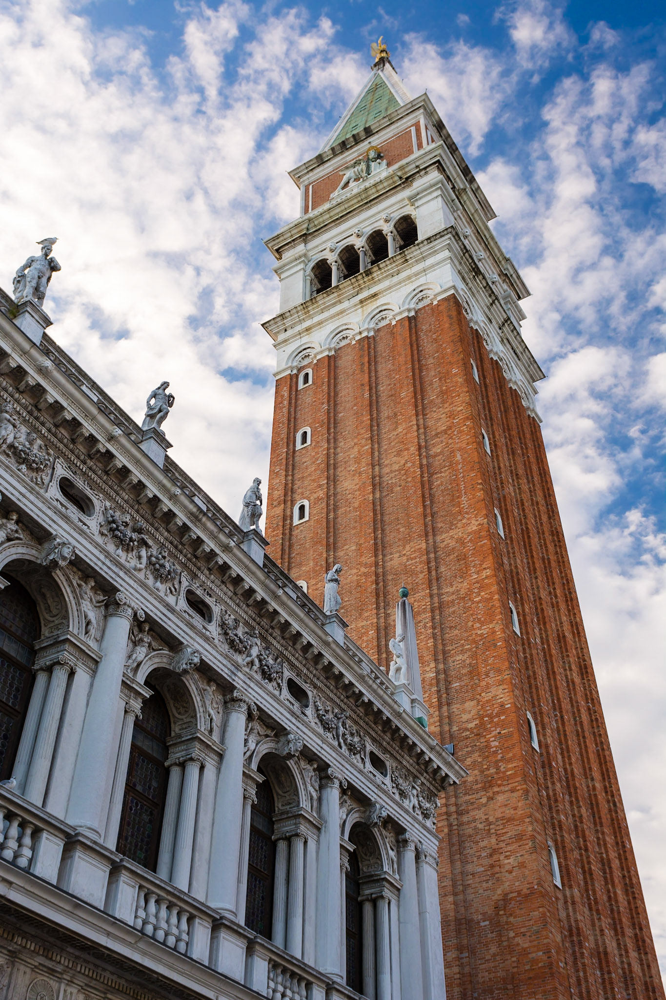 VENICE, ITALY, OCTOBER 10 2016: The Campanile San Marco is an imposing bell tower and one of the most recognisable structures in Venice. It overlooks the National Library of St Mark's.