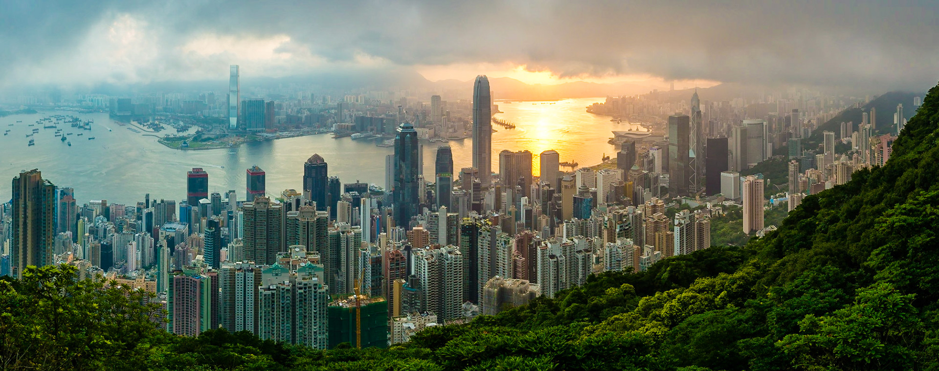 The famous view of Hong Kong from Victoria Peak. Taken at sunrise while the sun climbs over Kowloon Bay. The density of high-rise buildings is obvoius in this shot.