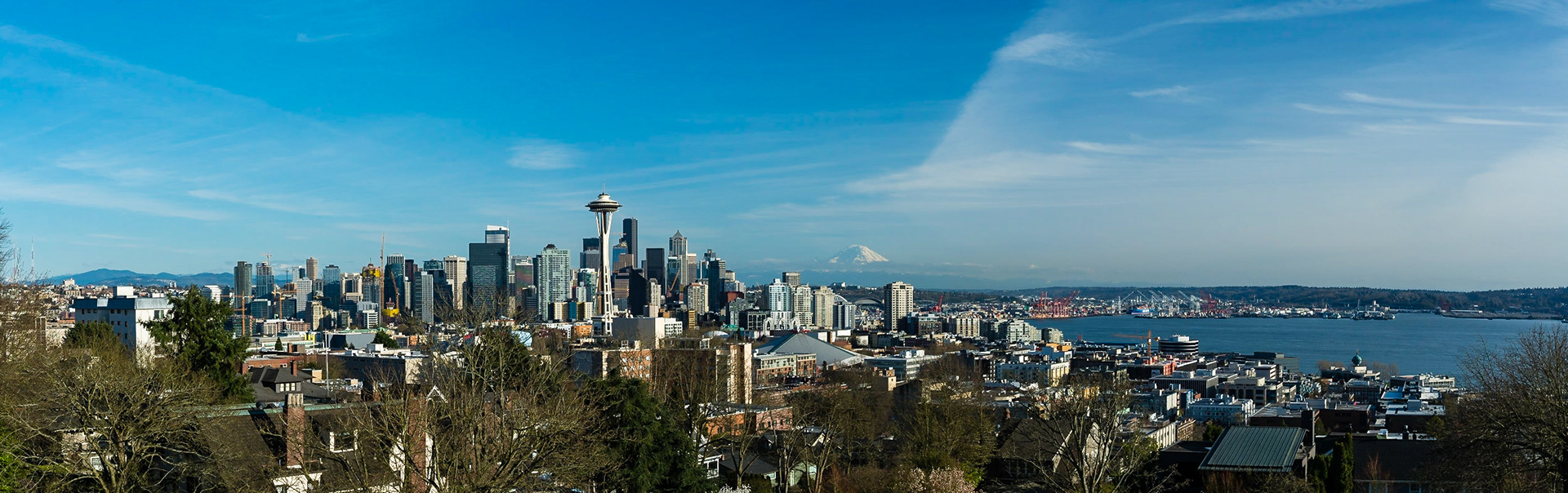 A classic view of Seattle, which includes the city, Space Needle, Elliot Bay and Mount Rainier.