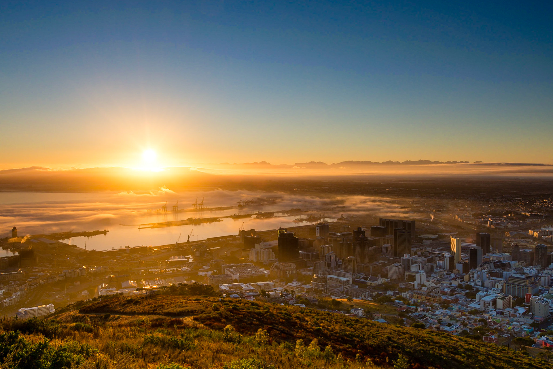 The view from Signal Hill just after sunrise, looking towards the V&amp;A Waterfront, docks and the distant Durbanville Hills.