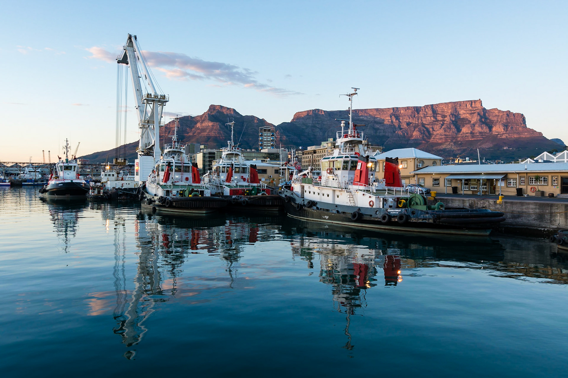 Sunrise at the  Victoria and Alfred Waterfront harbour in Cape Town, with Table Mountain in the background.