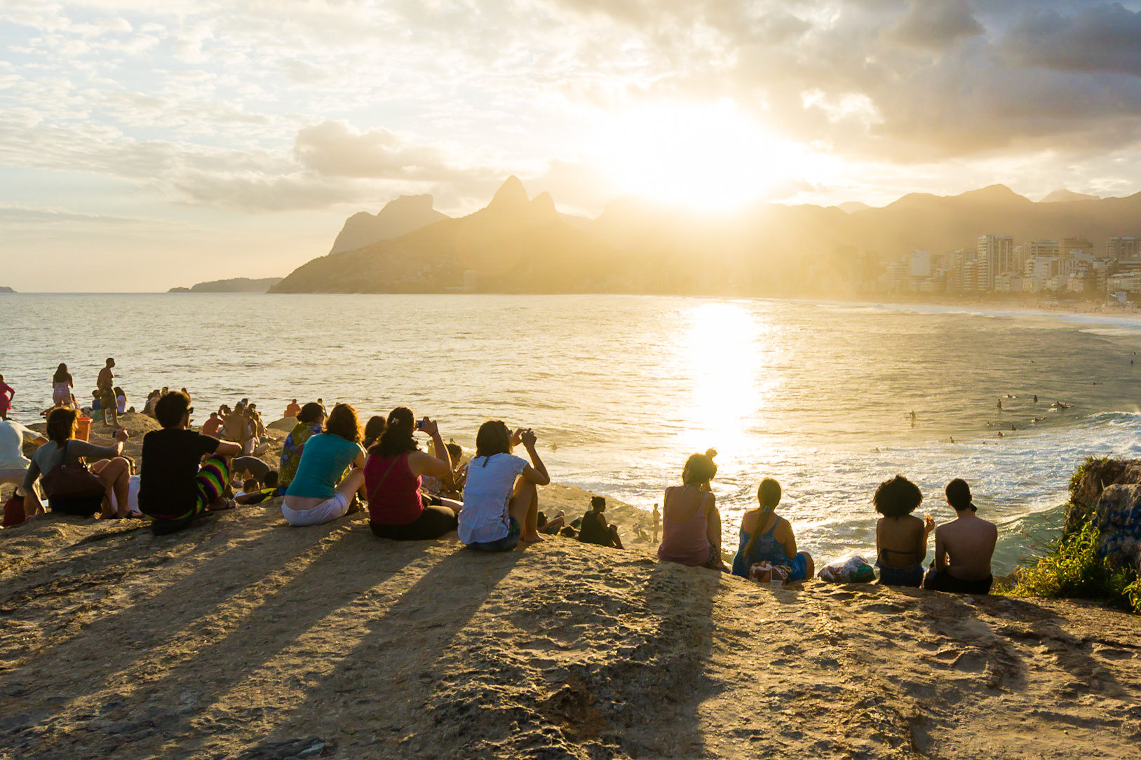 RIO DE JANEIRO, BRAZIL - APRIL 5 2015: Crowds gather on the rocks of Pedra do Arpoador in Rio de Janeiro to watch a spectacular sunset.