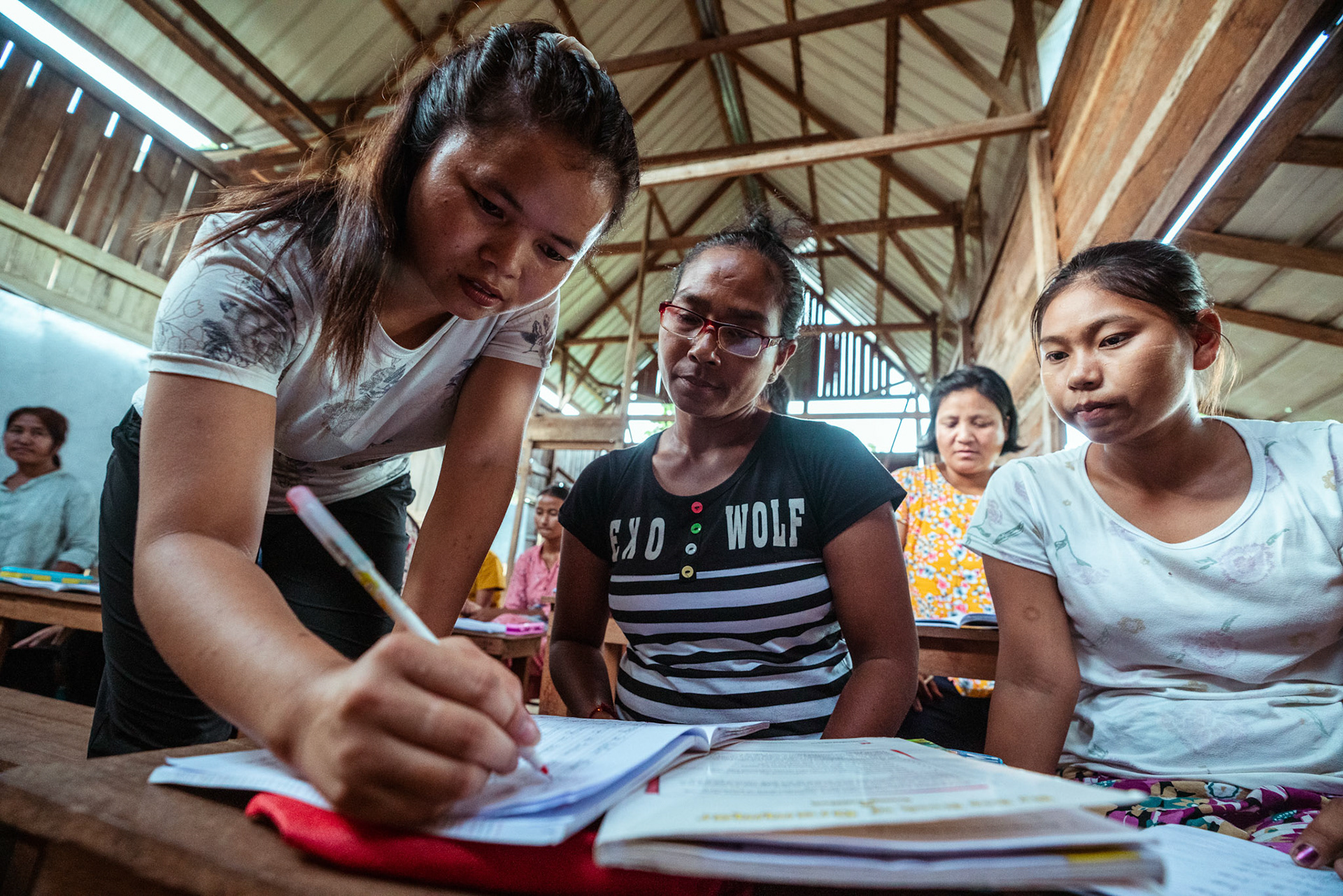 A teachers checks the study material as part of the adult education module organised by representatives of CRS Moreh, Manipur, during the COVID-19 Response and Recovery Program.