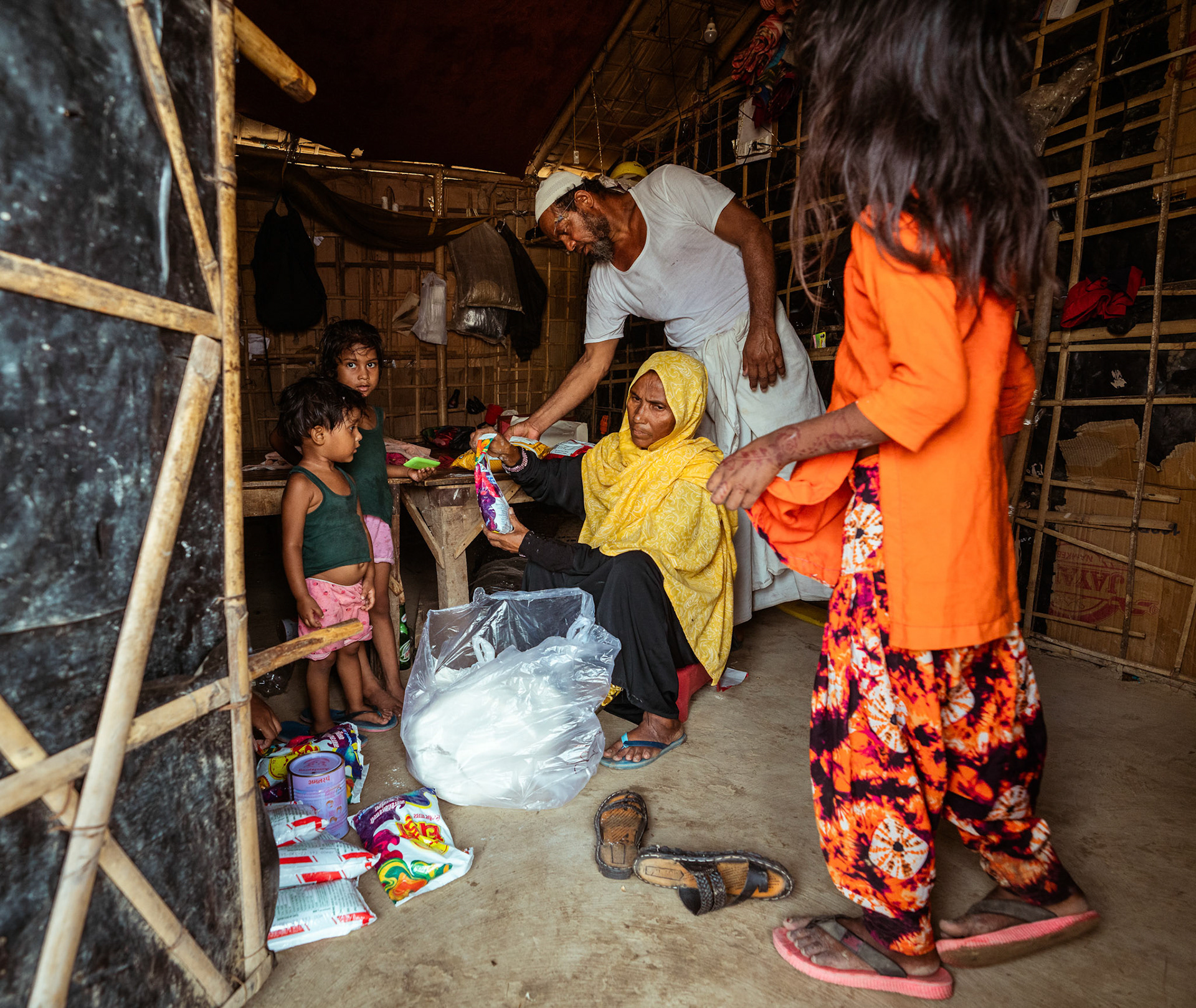Beneficiaries collecting basic need supplies and COVID recovery kits being distributed by Catholic Relief Services (CRS) as a part of COVID-19 Response and Recovery Program in Mewat, Haryana.