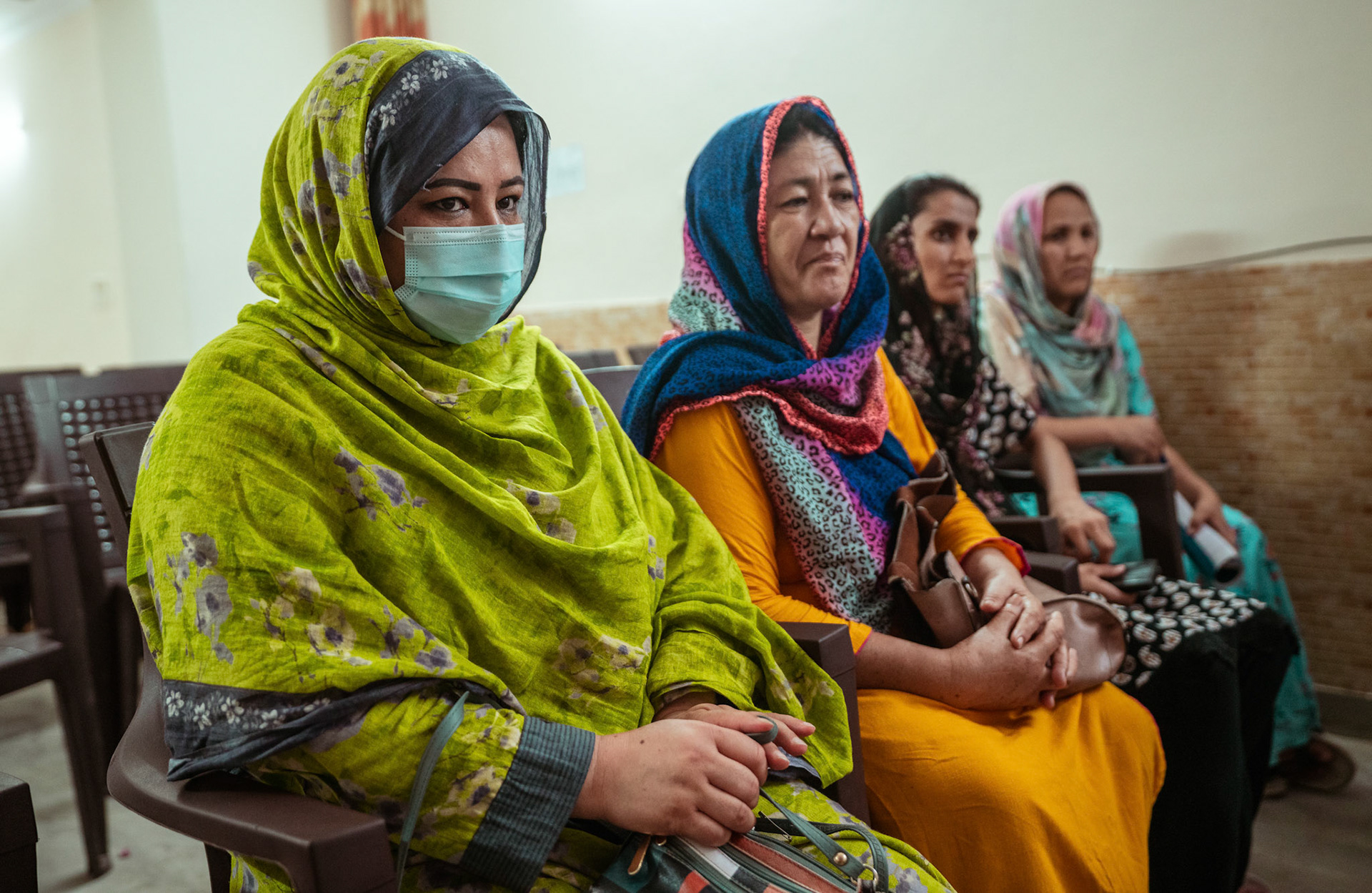 Afghan Refugees discuss a community event with Jesuit Relief Services (JRS) and Catholic Relief Services (CRS) teams at Tilak Nagar, Delhi.
