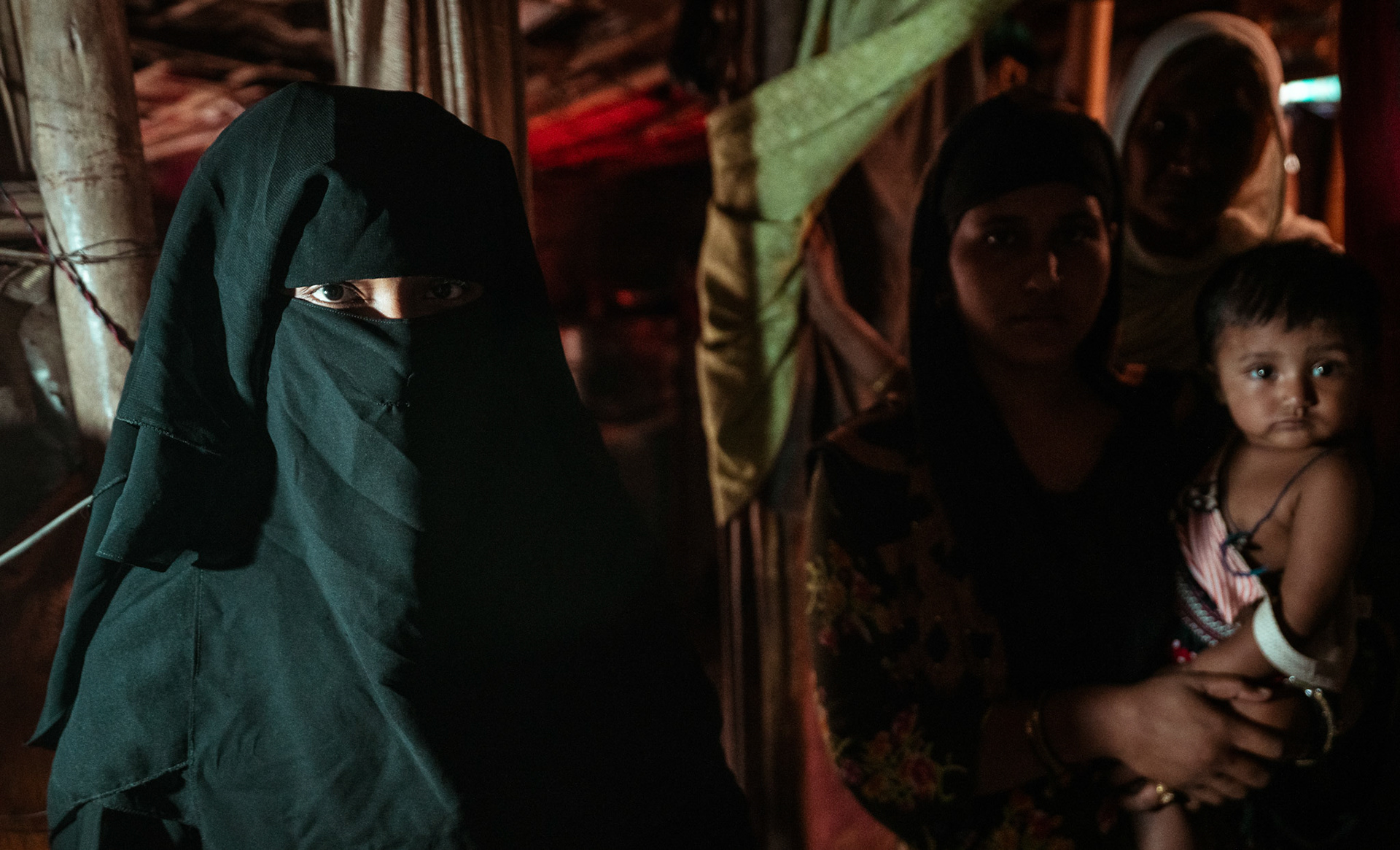 A group of refugees standing outside their home in Tilak Nagar, Delhi. The daughter, the mother informs us is extremely keen in educating herself but does not have enough access to education opportunities.