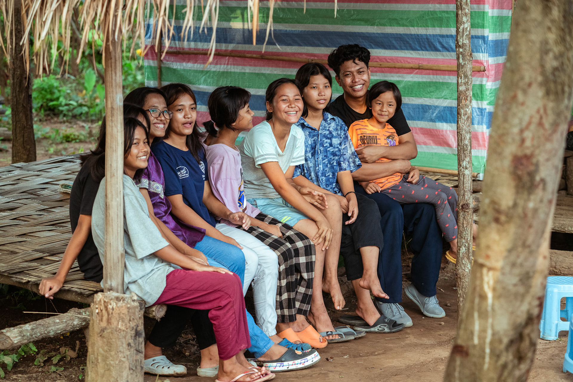 Young refugees of Moreh, Manipur, gather outside a medical camp organised by Catholic Relief Services (CRS)  as CRS representatives casually follow-up to enquire about their well-being.