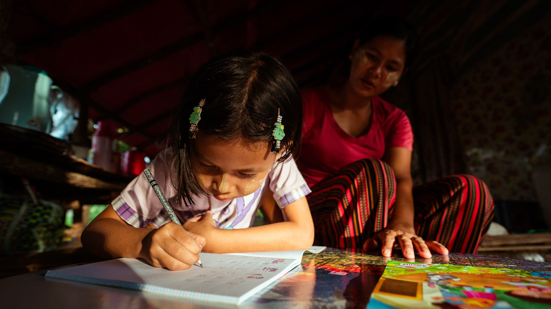 Mothers tutoring their children after attending skill development and adult education modules organised by members of CRS in Moreh, Manipur.