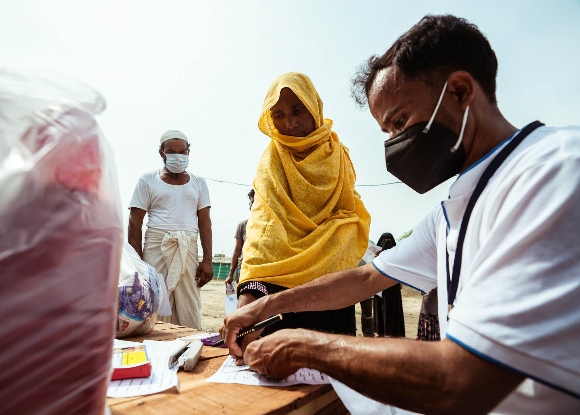 Representatives of Catholic Relief Services (CRS) carrying out the Voucher Based Distribution of basic need supplies and COVID recovery kits among refugees in Mewat, Haryana.