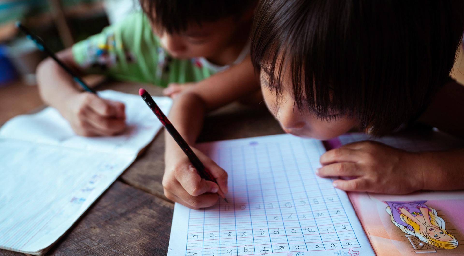 Mothers tutoring their children after attending skill development and adult education modules organised by members of CRS in Moreh, Manipur.