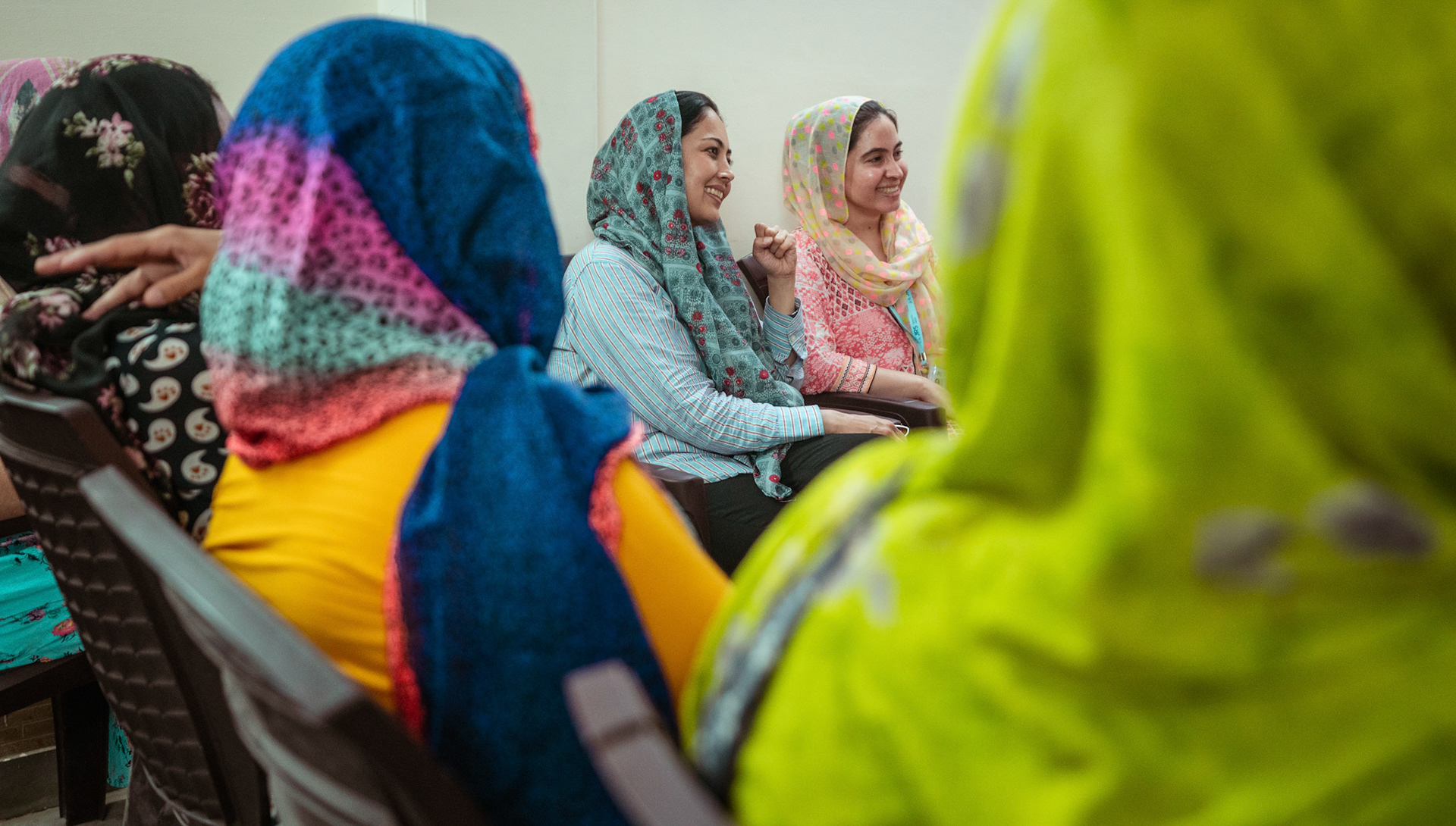 Afghan Refugees discuss a community event with Jesuit Relief Services (JRS) and Catholic Relief Services (CRS) teams at Tilak Nagar, Delhi.