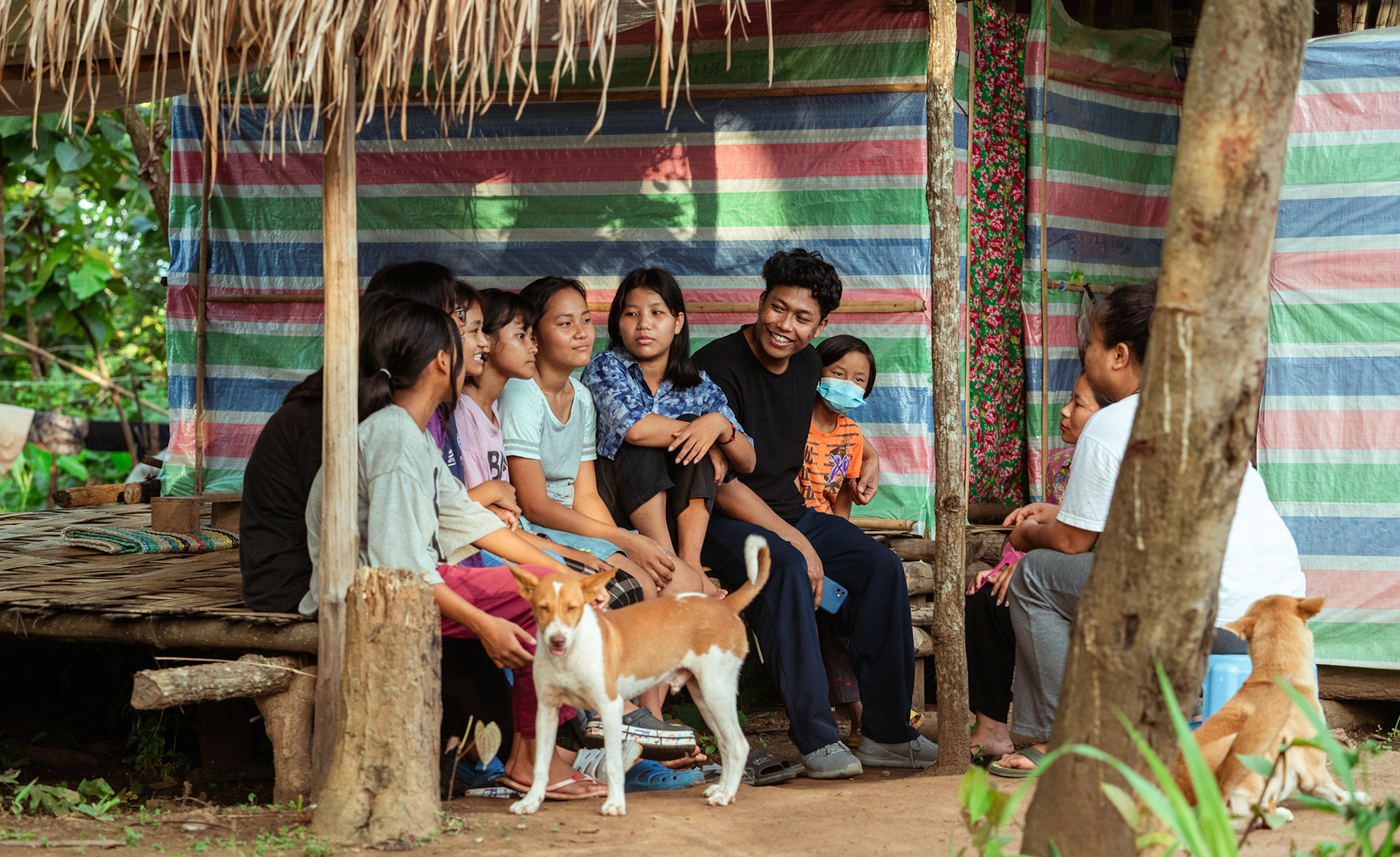 Young refugees of Moreh, Manipur, gather outside a medical camp organised by Catholic Relief Services (CRS)  as CRS representatives casually follow-up to enquire about their well-being.