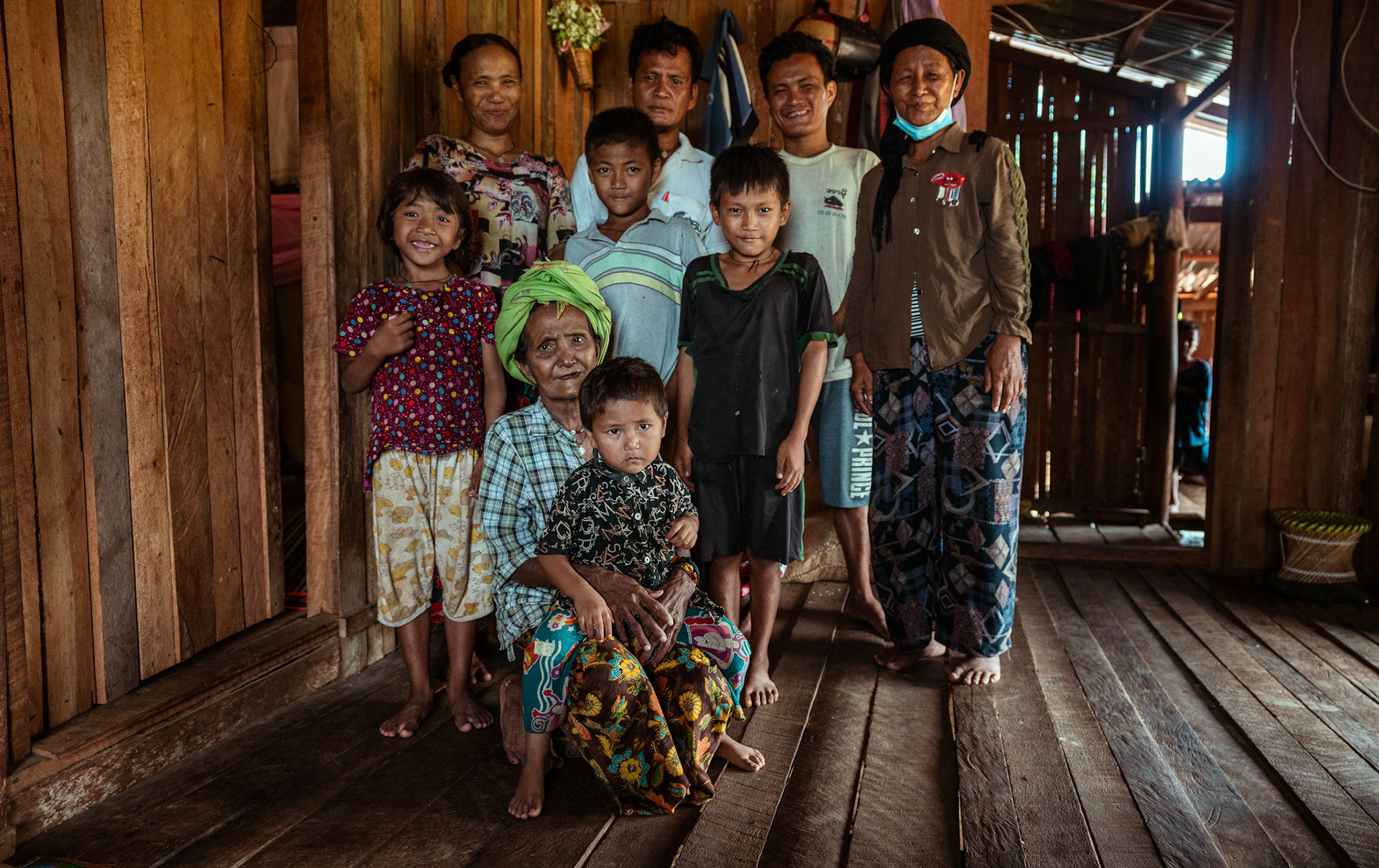 A refugee family standing outside their home in Moreh, Manipur, during the COVID-19 Response and Recovery Program.