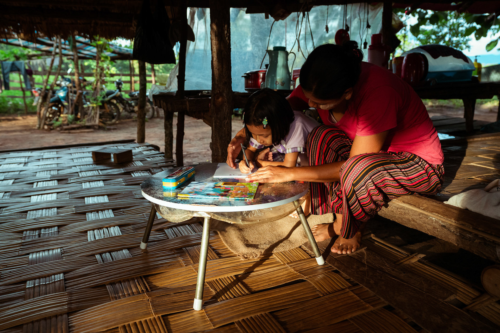Mothers tutoring their children after attending skill development and adult education modules organised by members of CRS in Moreh, Manipur.