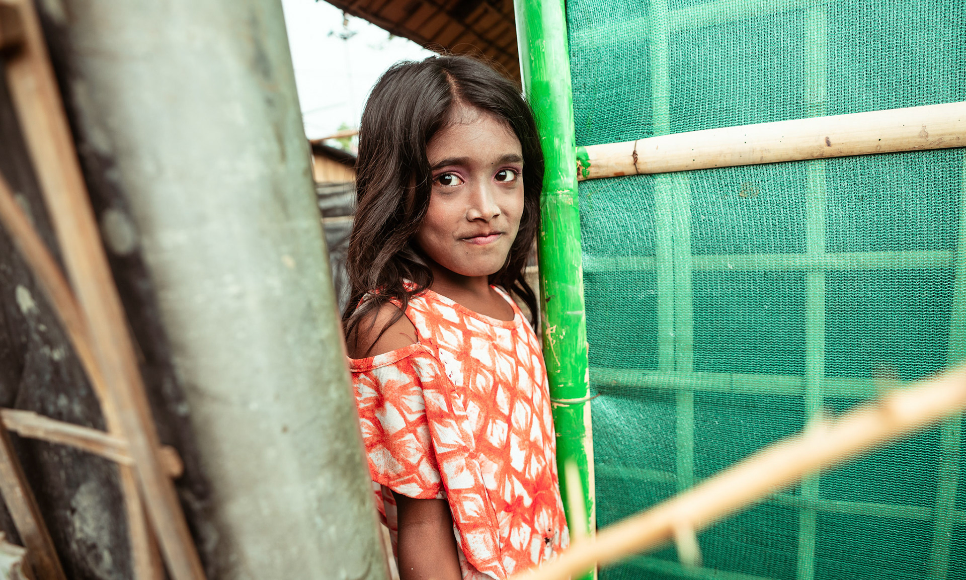 A Rohingya refugee girl standing outside her home during the COVID-19 Response and Recovery Program in Tilak Nagar, Delhi.