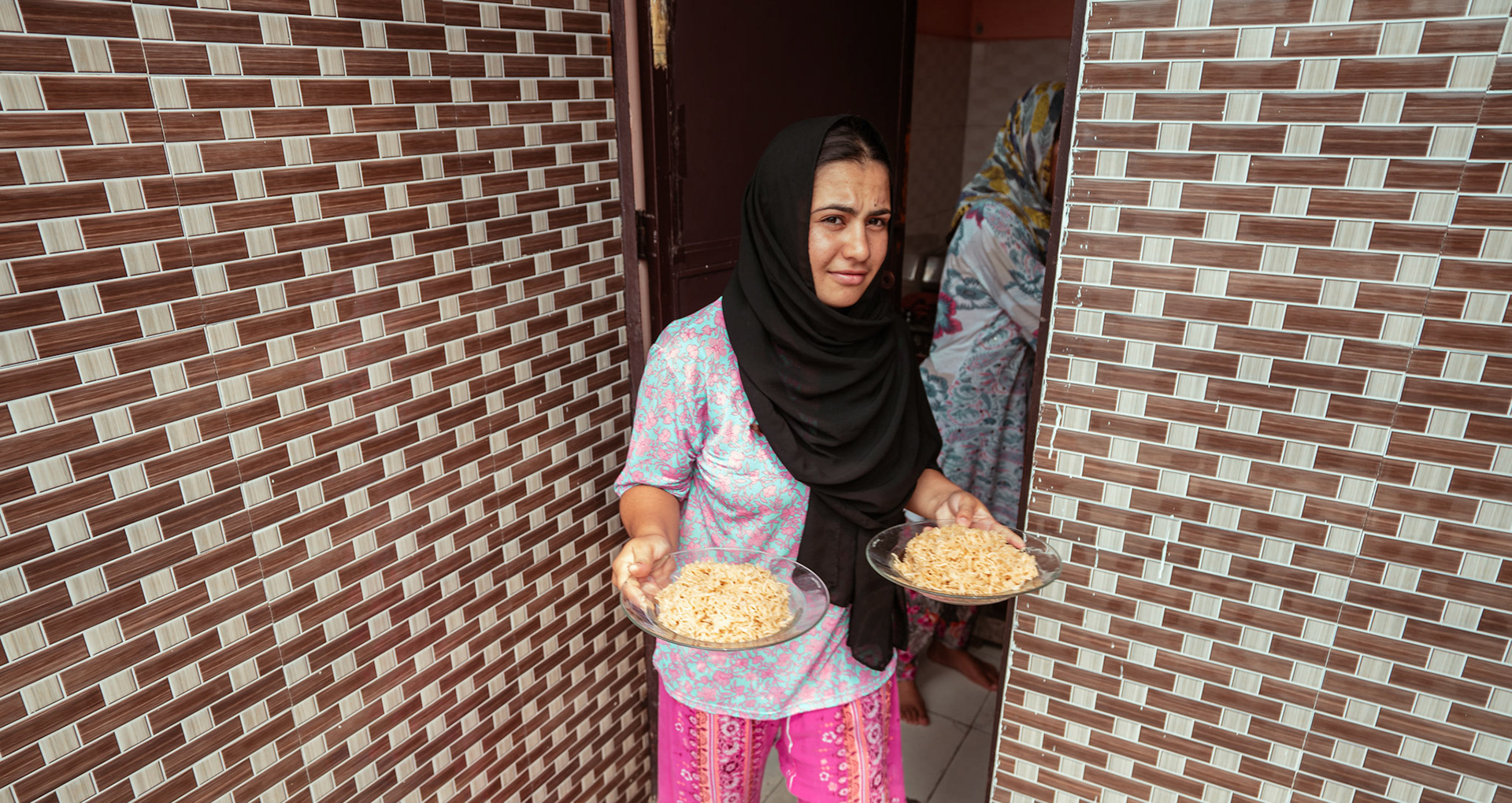 An Afghan Refugee assits lunch preparations at her home in Tilak Nagar, Delhi, during the relief project organised by Catholic Relief Services (CRS)