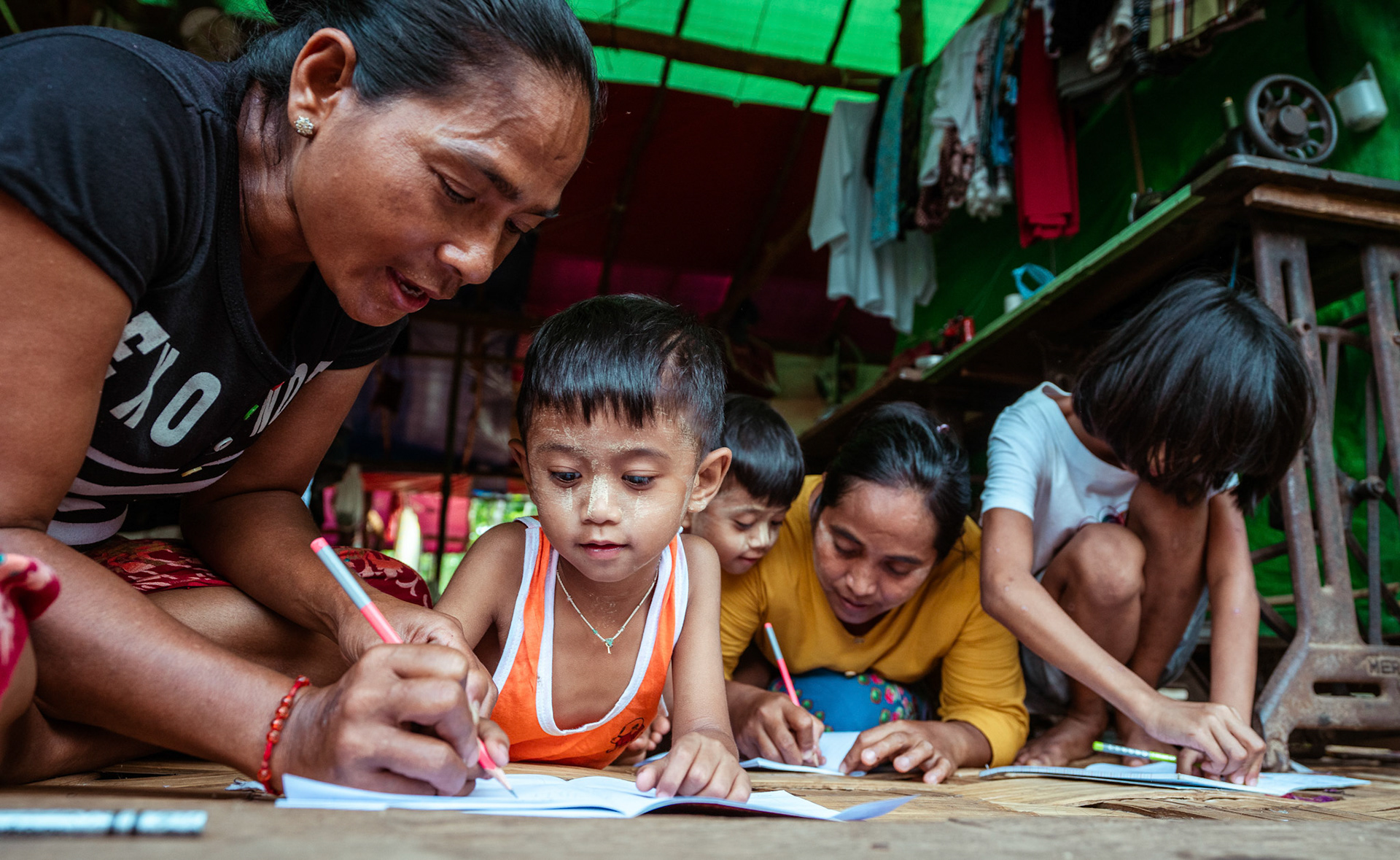 Mothers tutoring their children after attending skill development and adult education modules organised by members of CRS in Moreh, Manipur.